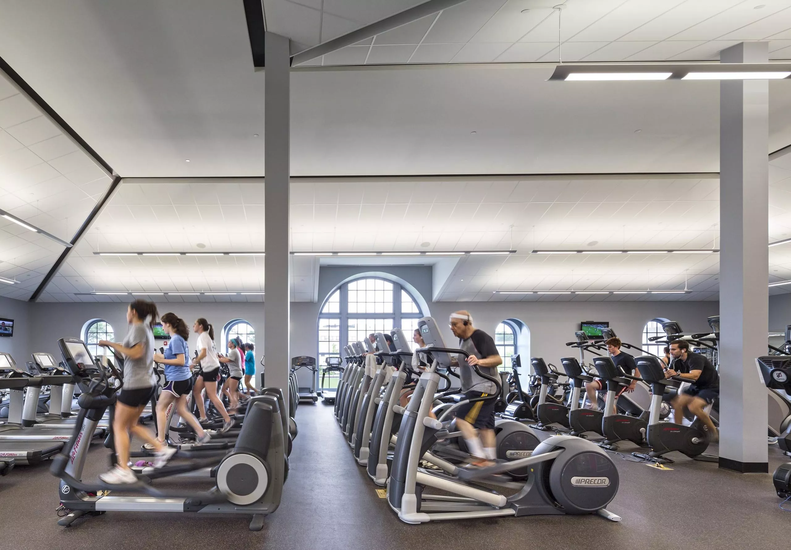 People on exercise equipment inside Nelson Fitness & Coleman Aquatics Center