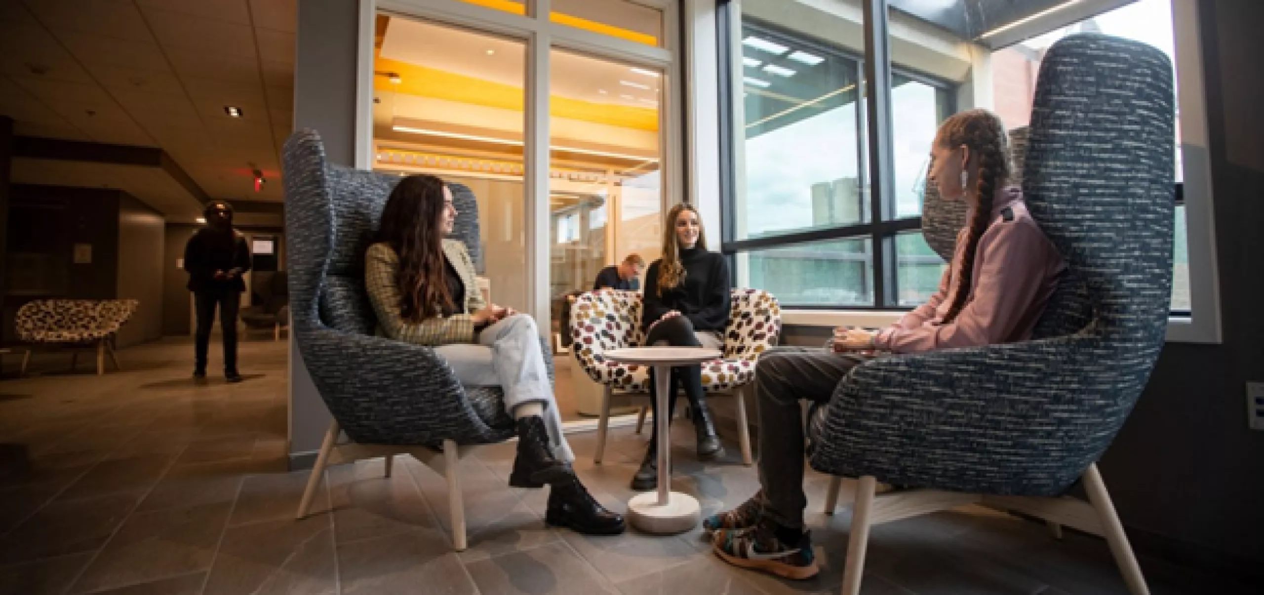 students sitting in chairs talking to each other