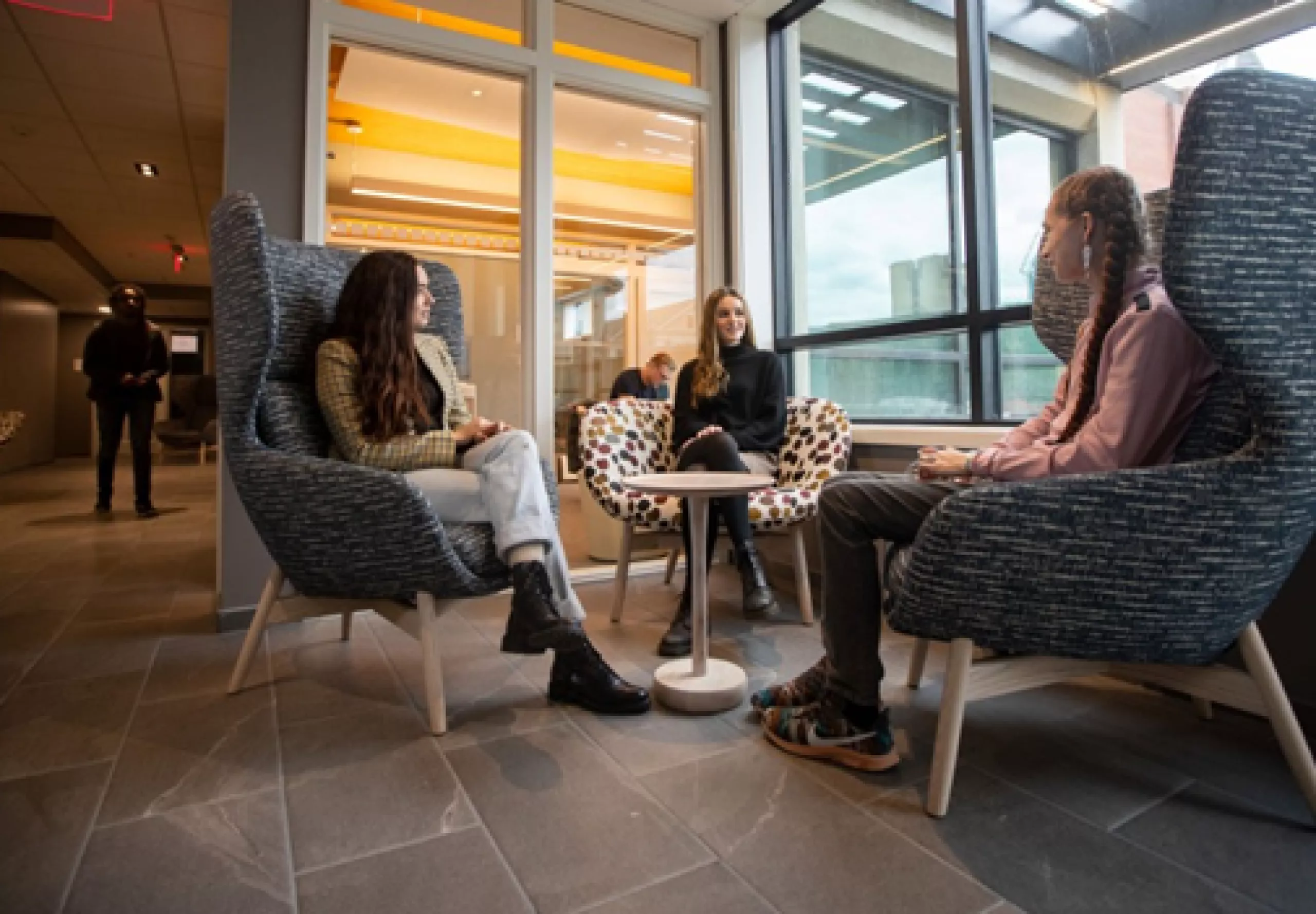 students sitting in chairs talking to each other