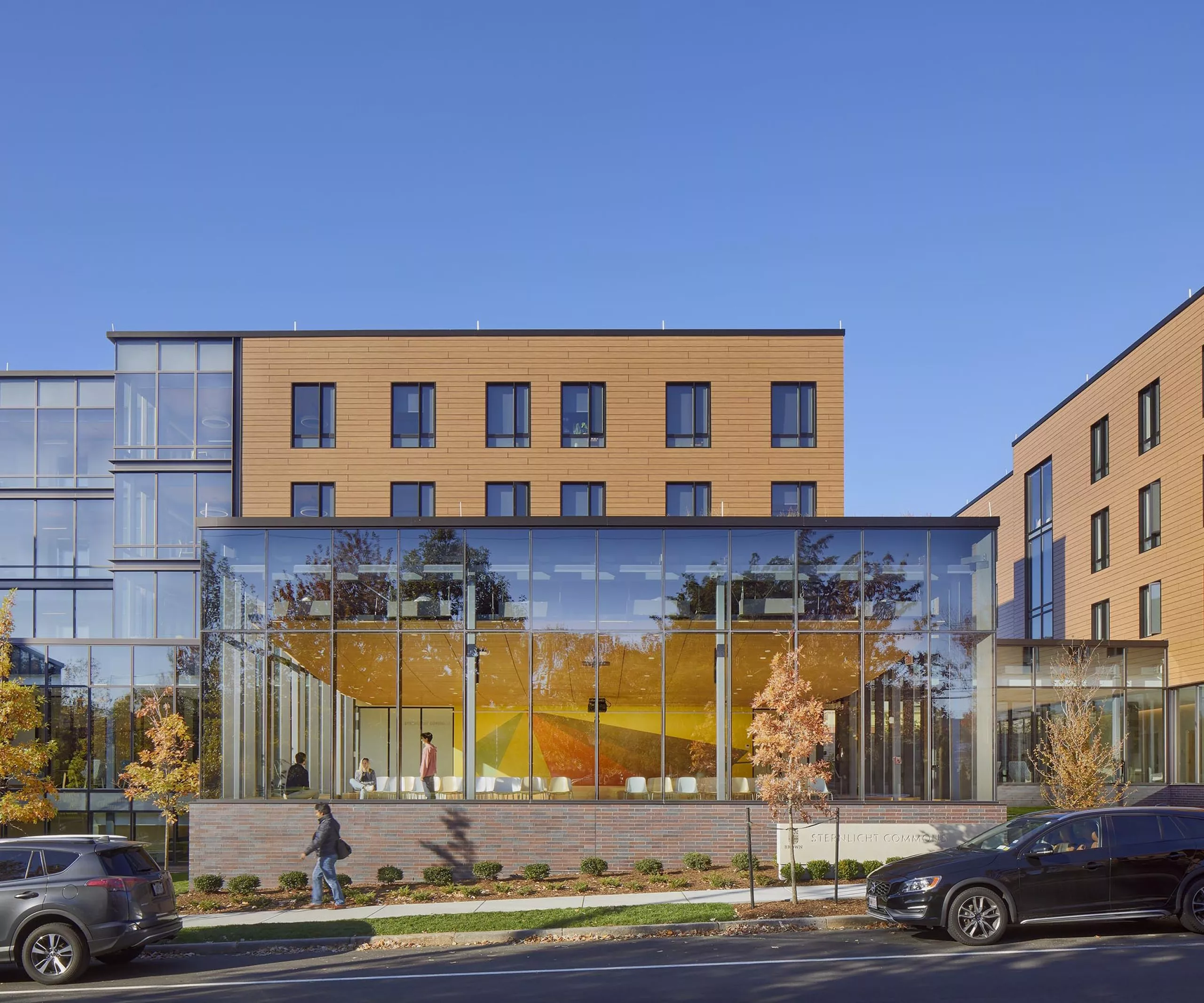 Street view of Sternlicht Residential Commons and Health & Wellness Center with large windows