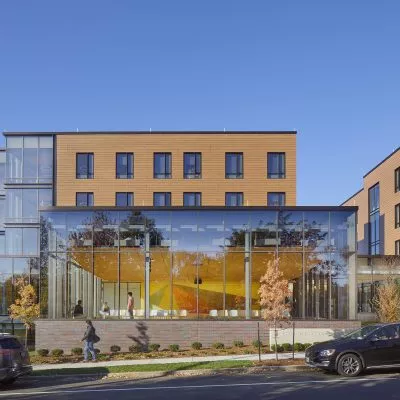 Street view of Sternlicht Residential Commons and Health & Wellness Center with large windows