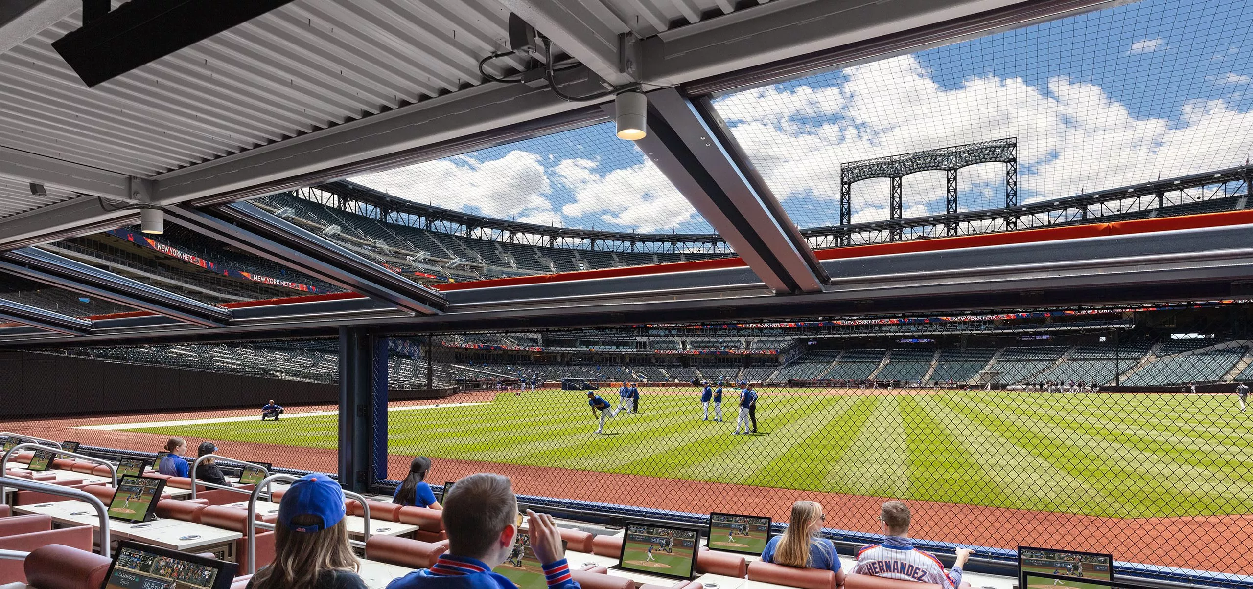 People sitting at boxes with field view of Citi Field Stadium