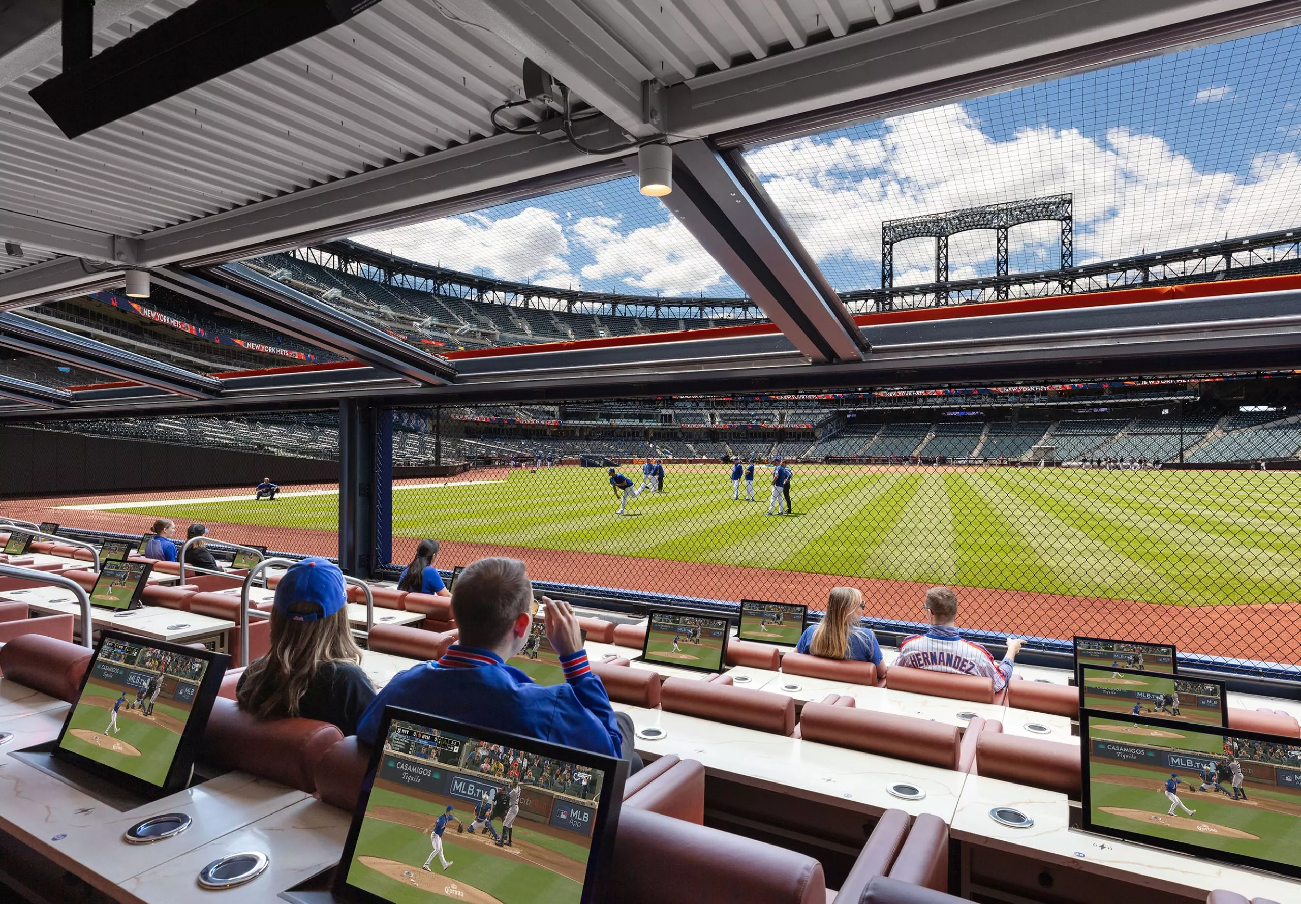 People sitting at boxes with field view of Citi Field Stadium