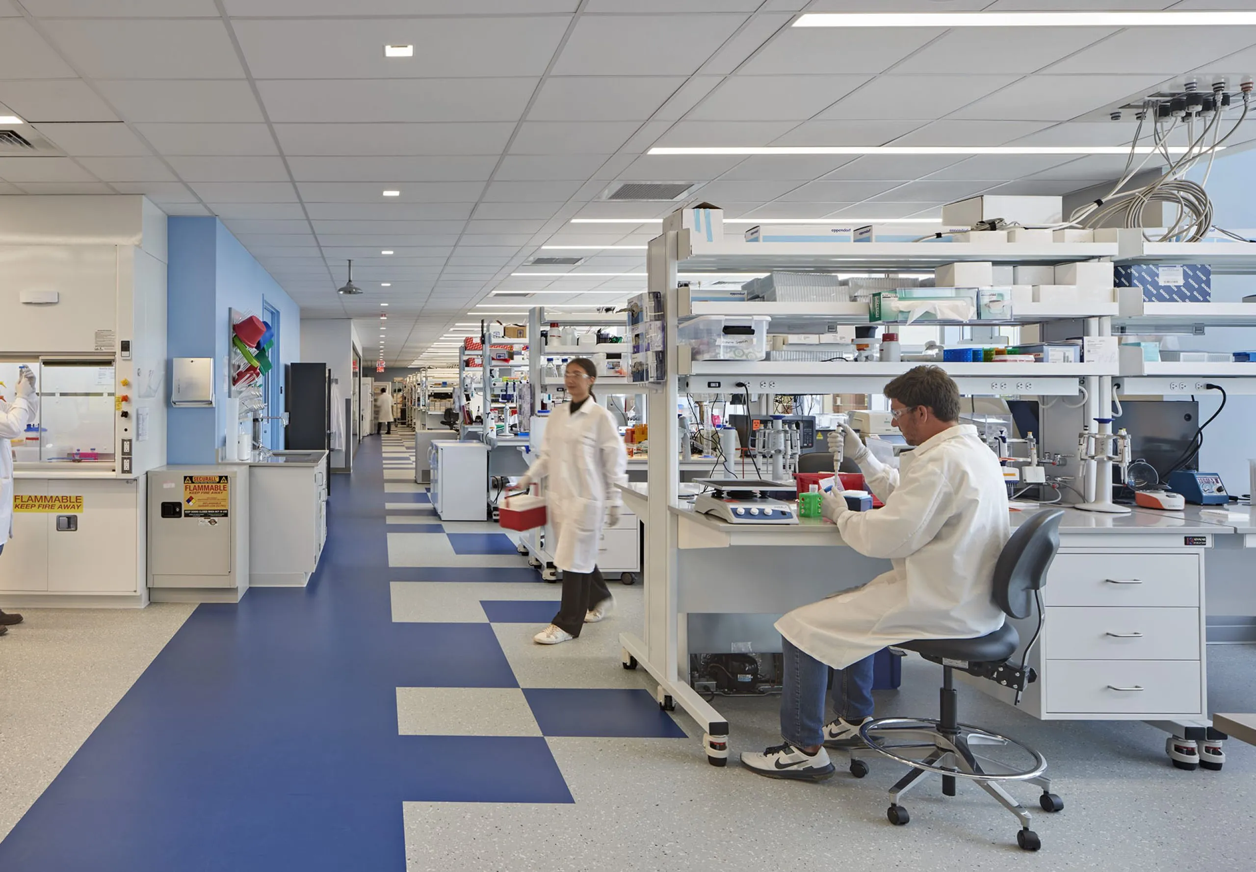 people in lab coats working in a lab