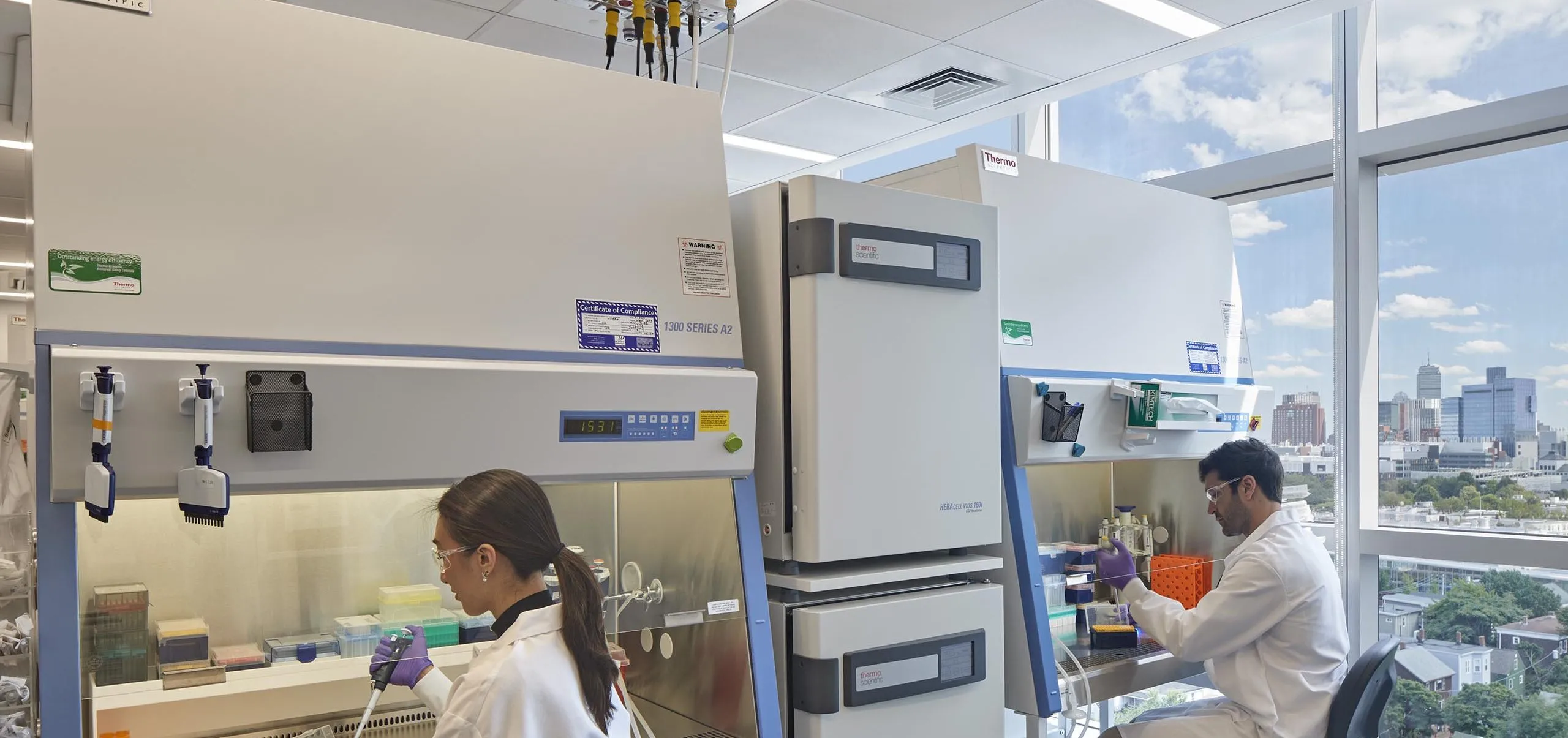 interior view of a lab with two people in lab coats working