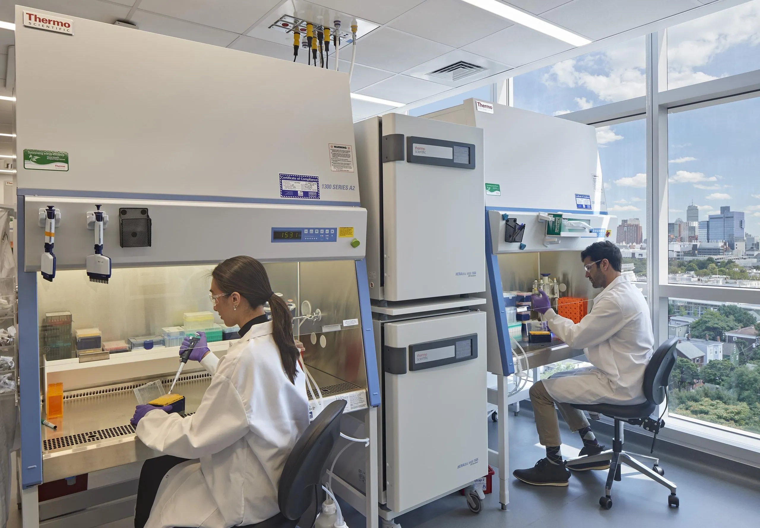 interior view of a lab with two people in lab coats working