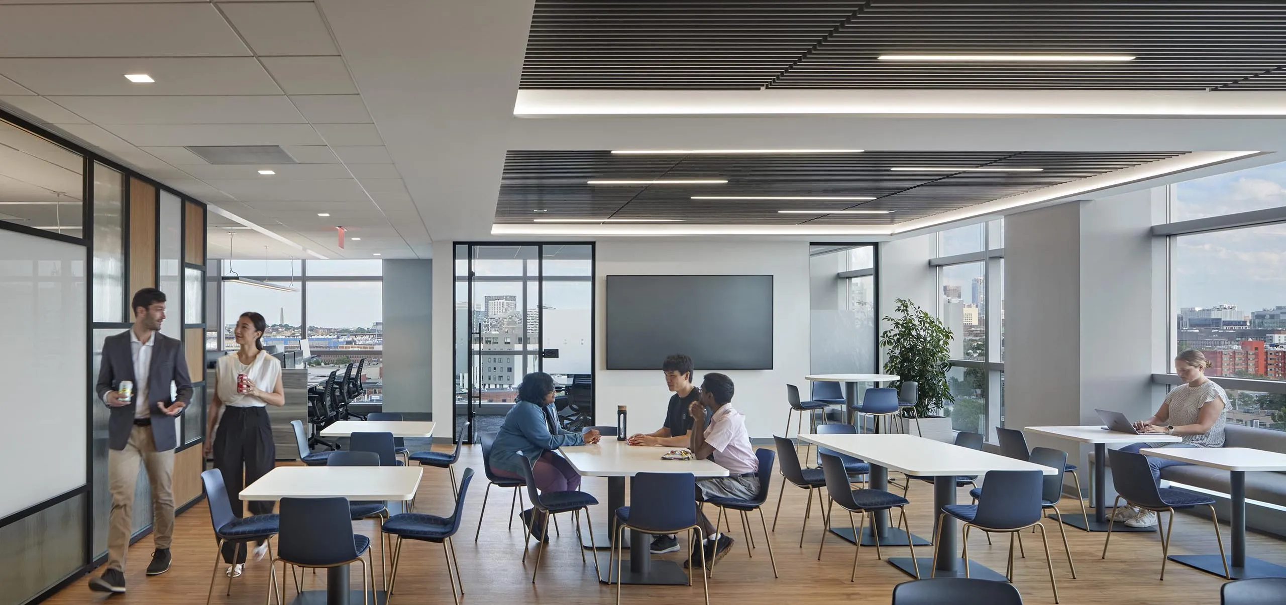 interior view of the employee lunchroom with people sitting at tables talking