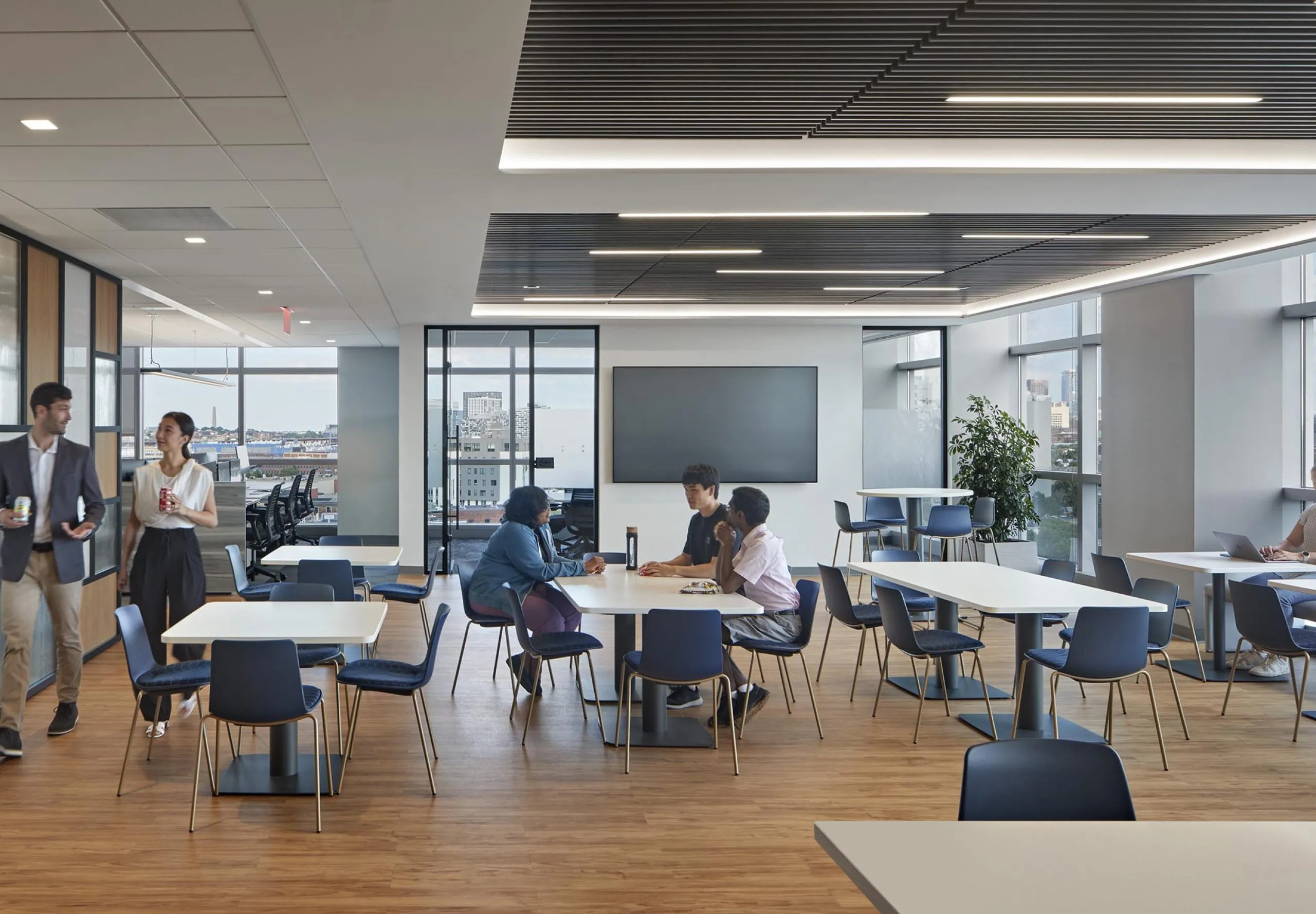 interior view of the employee lunchroom with people sitting at tables talking