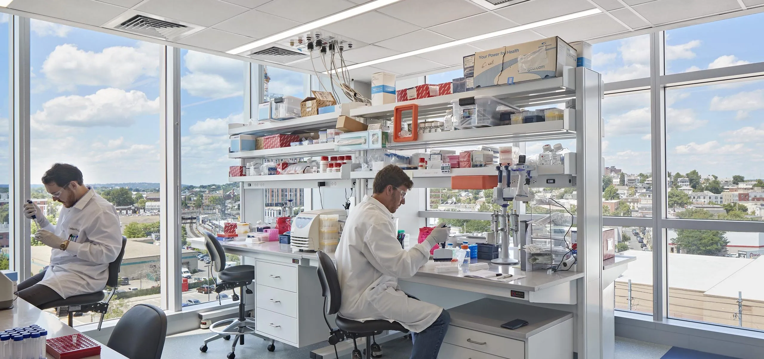 interior view of a lab with two people in lab coats working