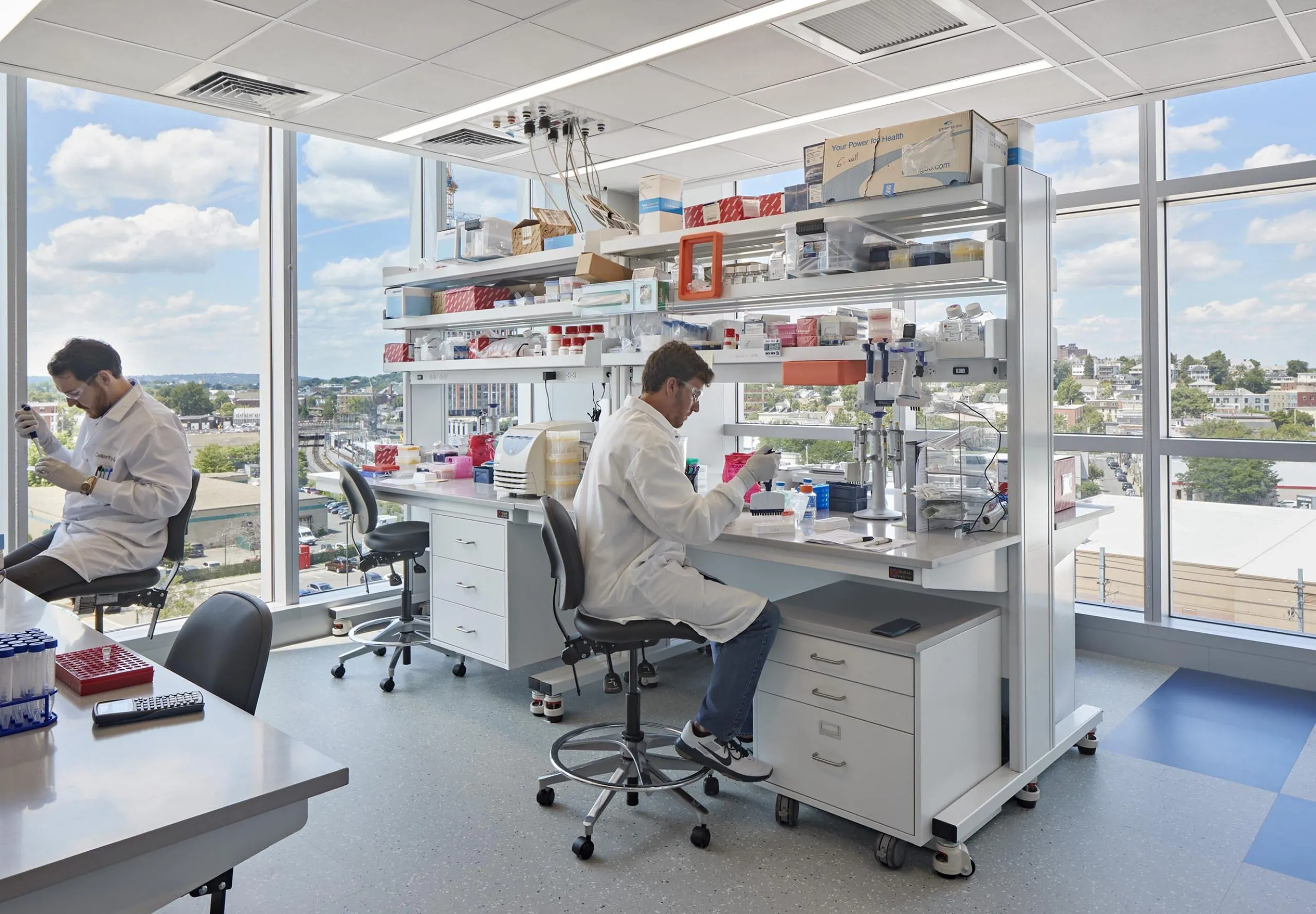 interior view of a lab with two people in lab coats working