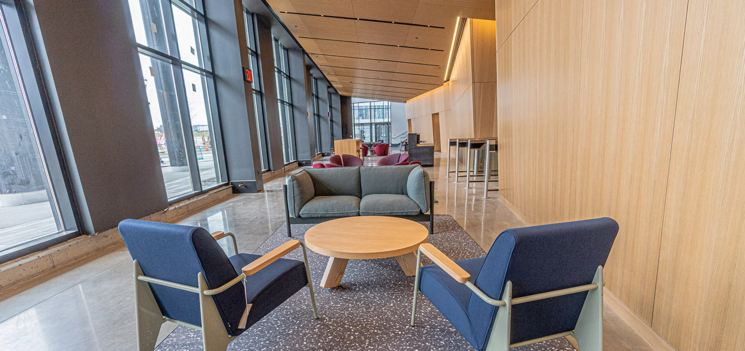 interior view of a hallway with two chairs, couch, and a small round table