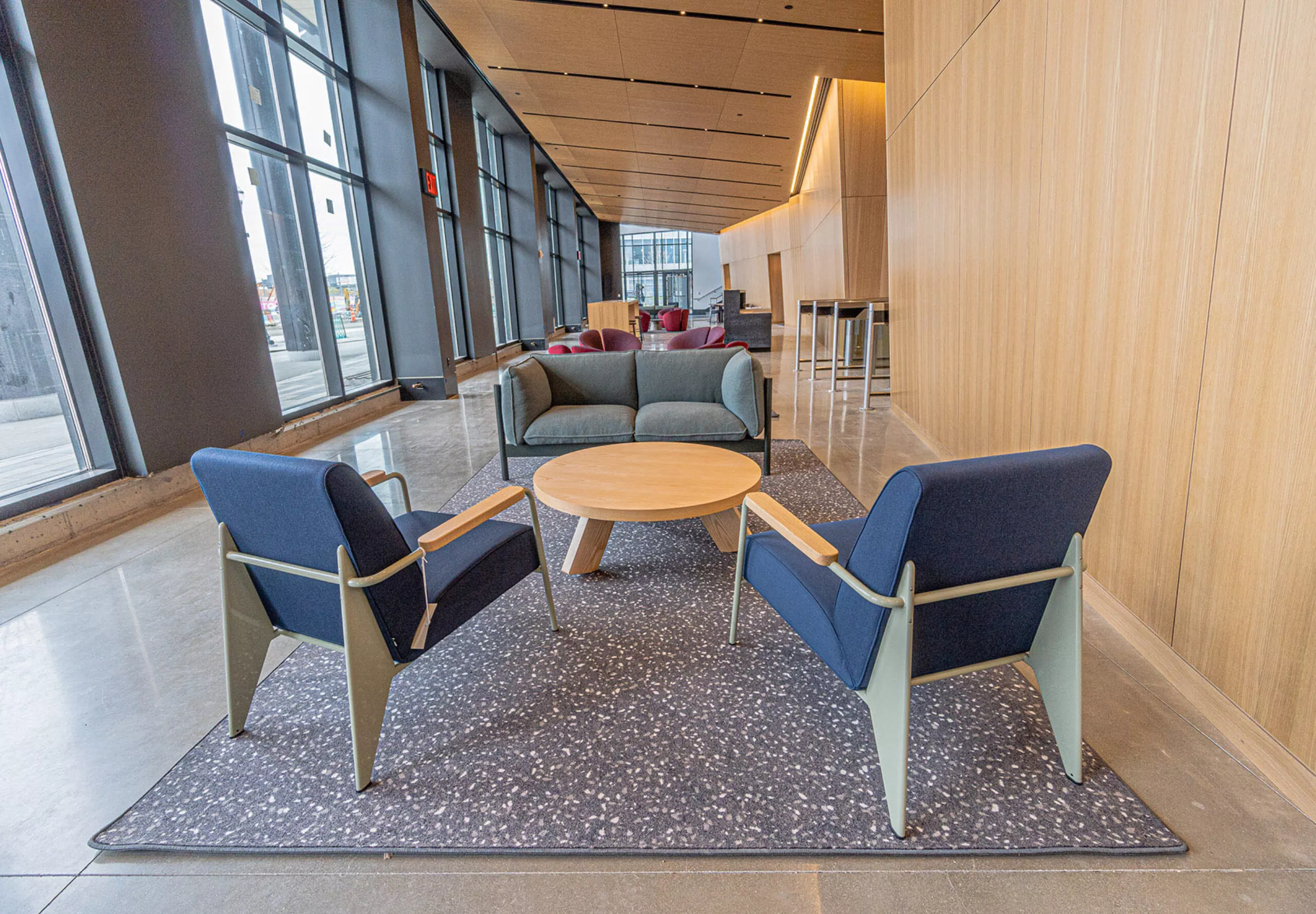 interior view of a hallway with two chairs, couch, and a small round table