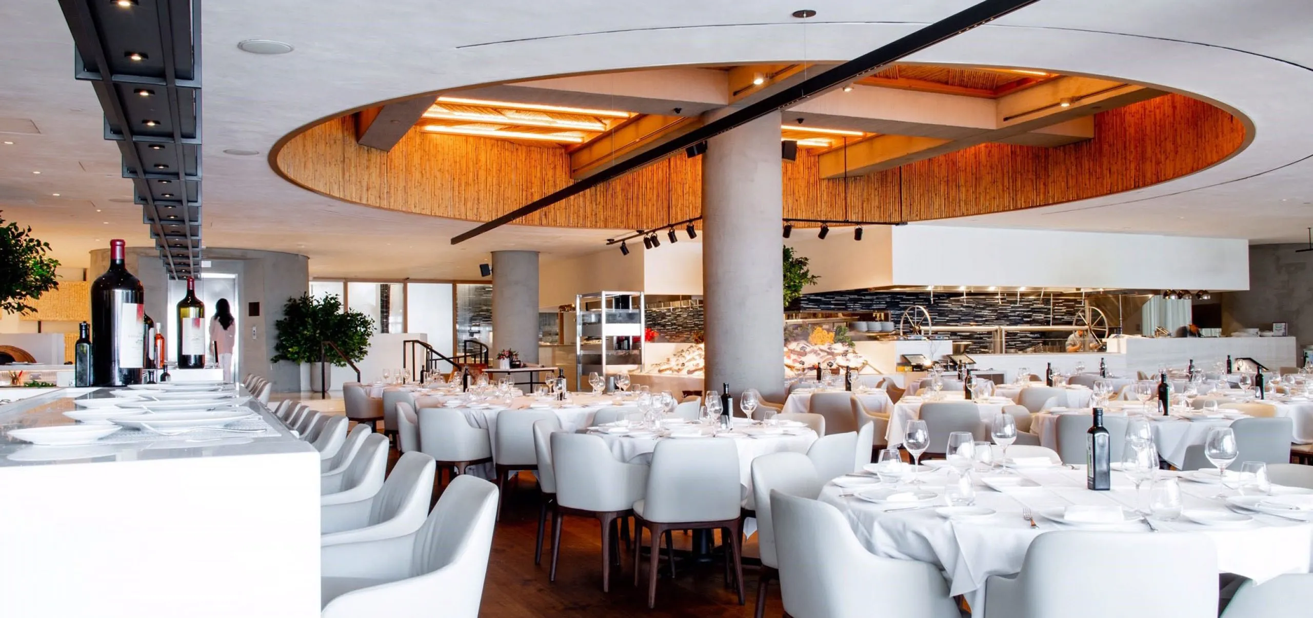 Interior view of the dining room and kitchen at Estiatorio Milos