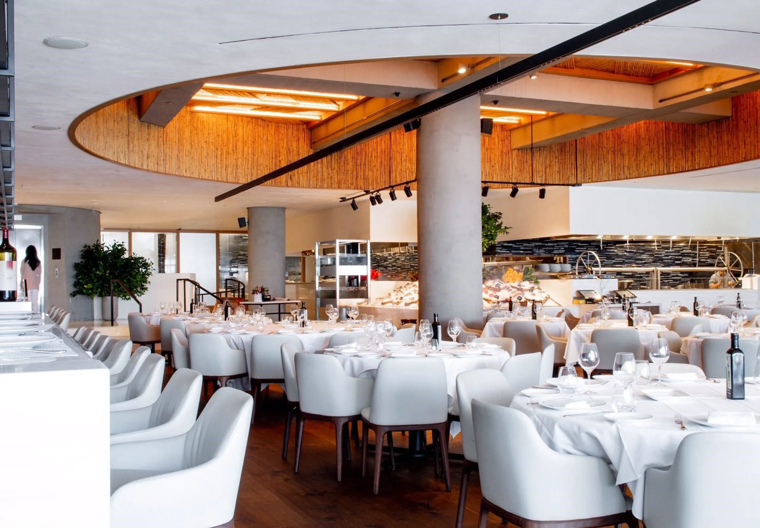 Interior view of the dining room and kitchen at Estiatorio Milos