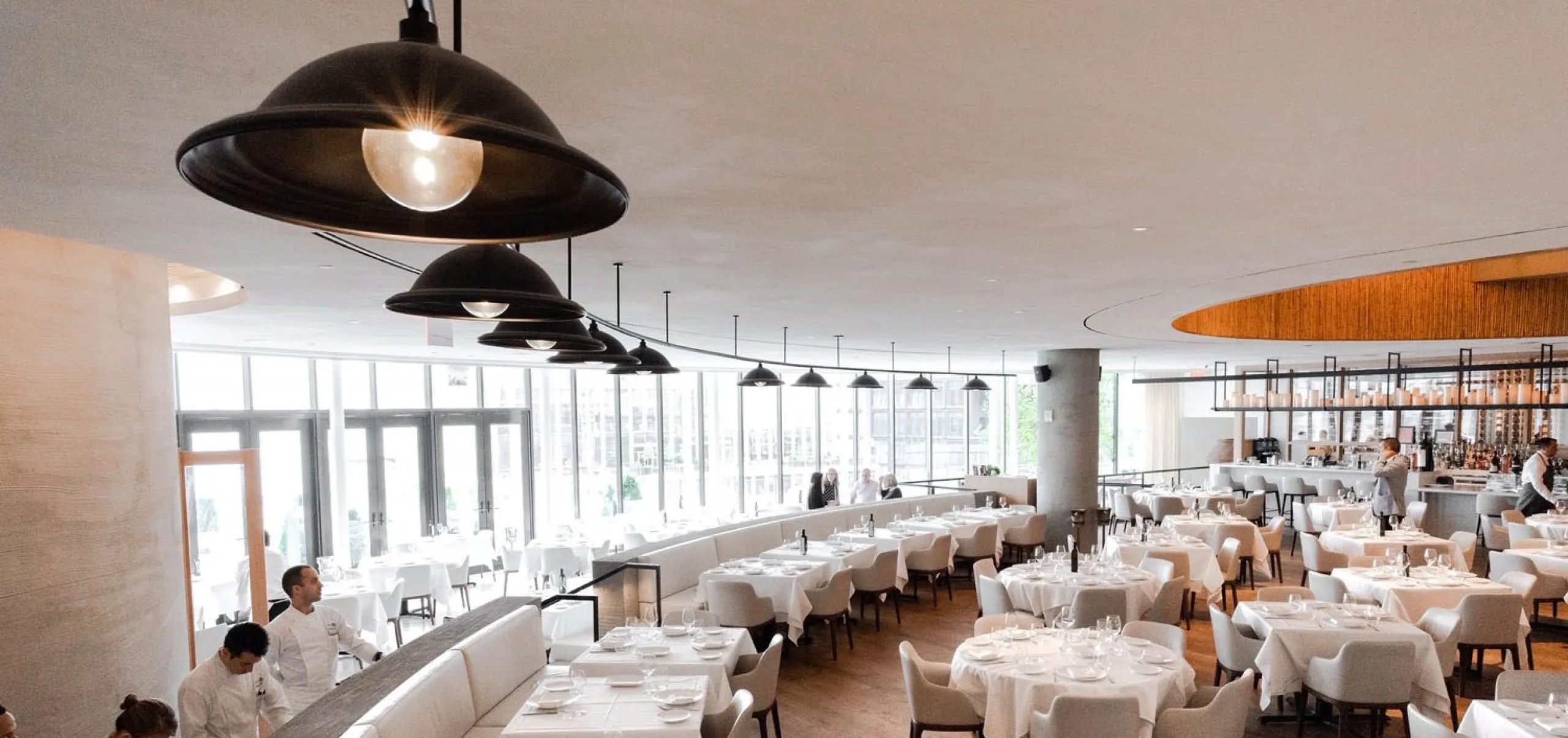 Interior view of the dining room and kitchen at Estiatorio Milos