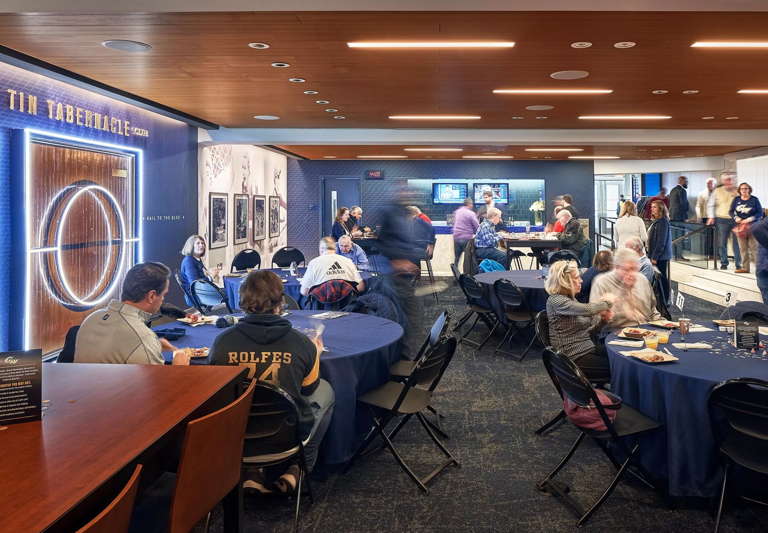 People sitting at tables in the Tin Tabernacle Club at the Charles E Smith Center