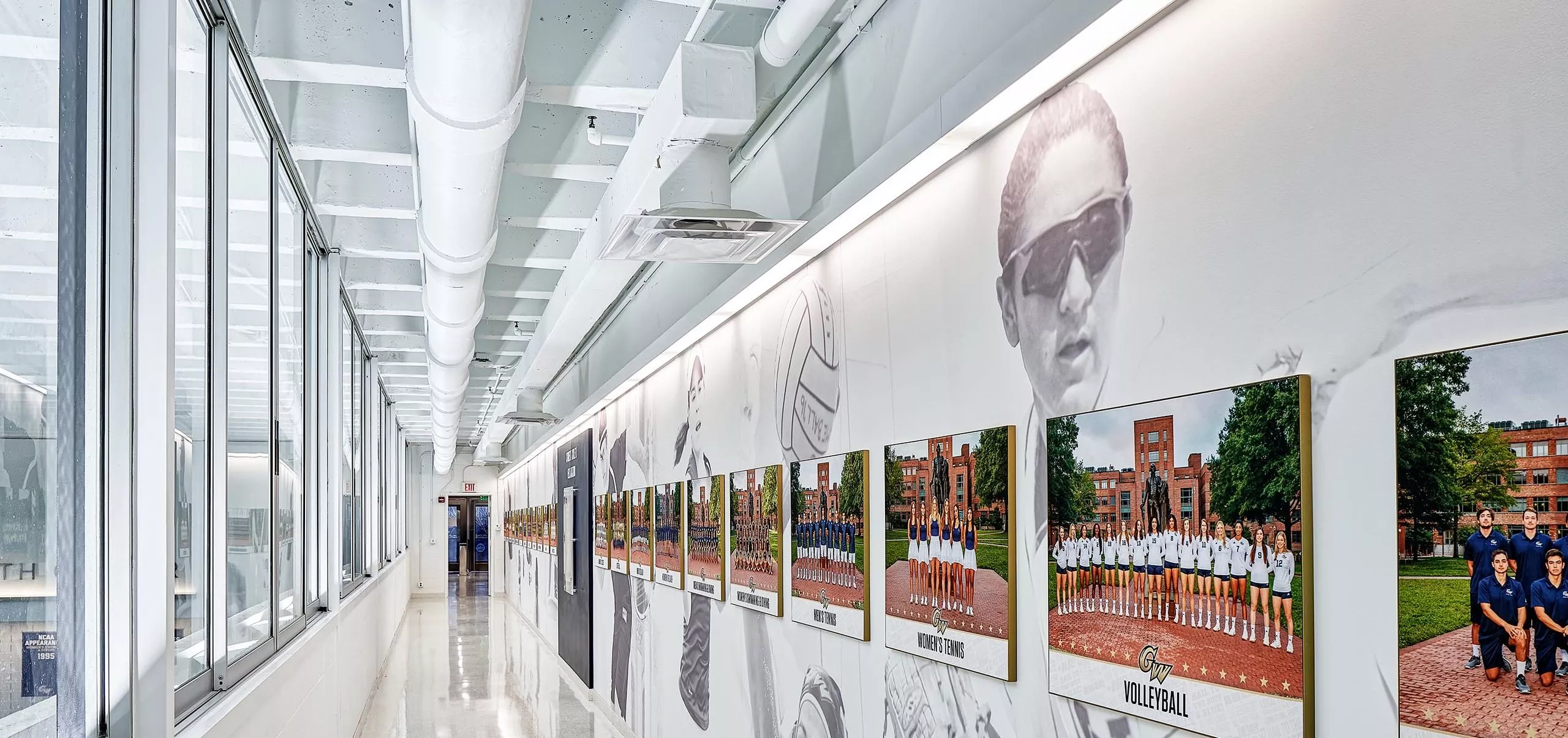 Photographs of sports teams along a hallway in the Charles E. Smith Center