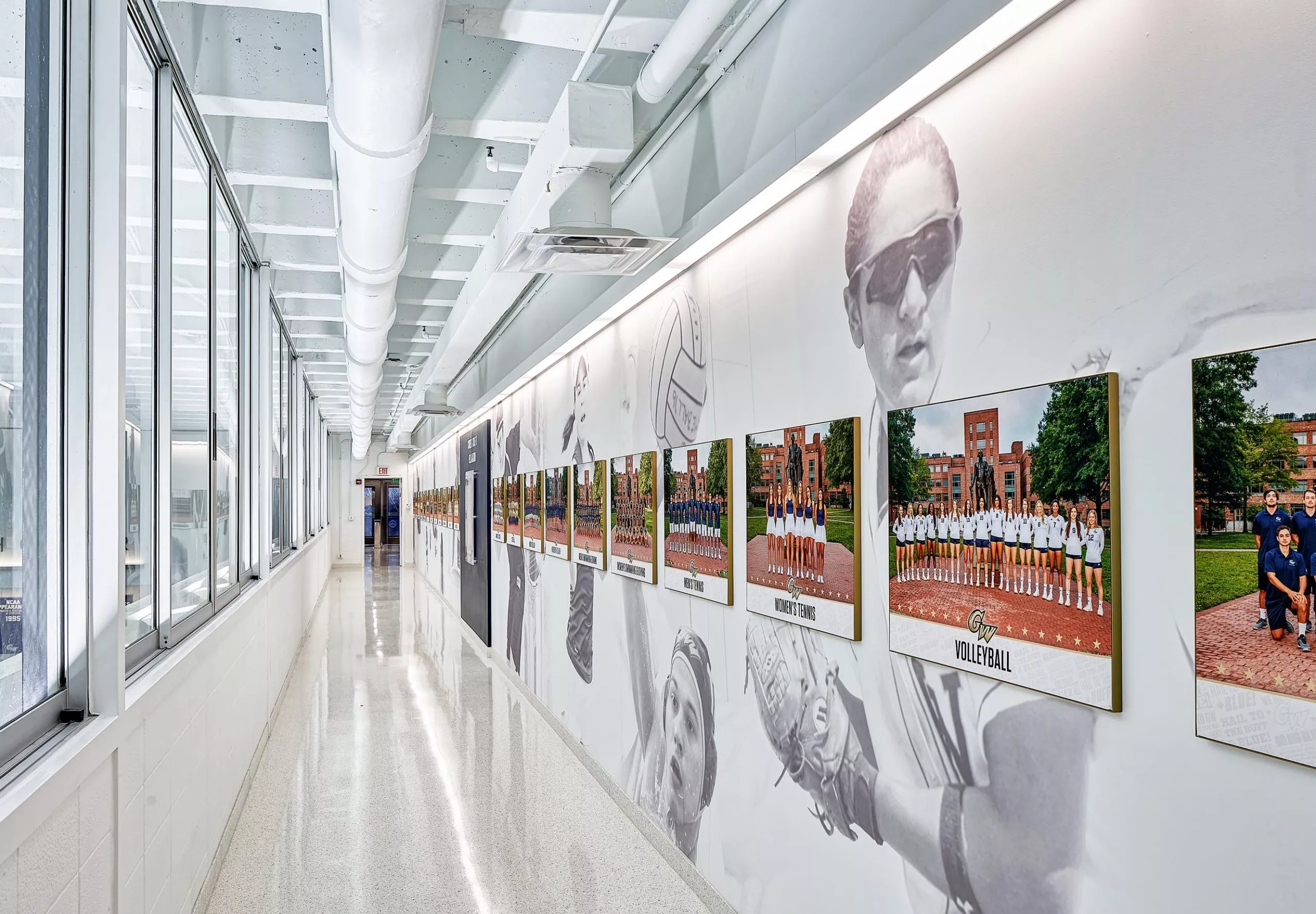 Photographs of sports teams along a hallway in the Charles E. Smith Center