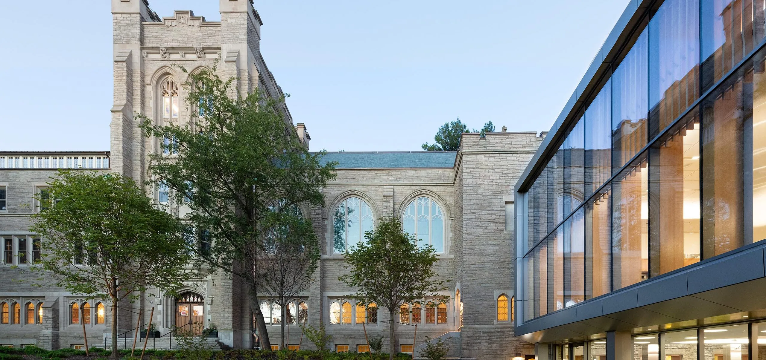 People sitting in seating area outside of Harvard Divinity School – Swartz Hall