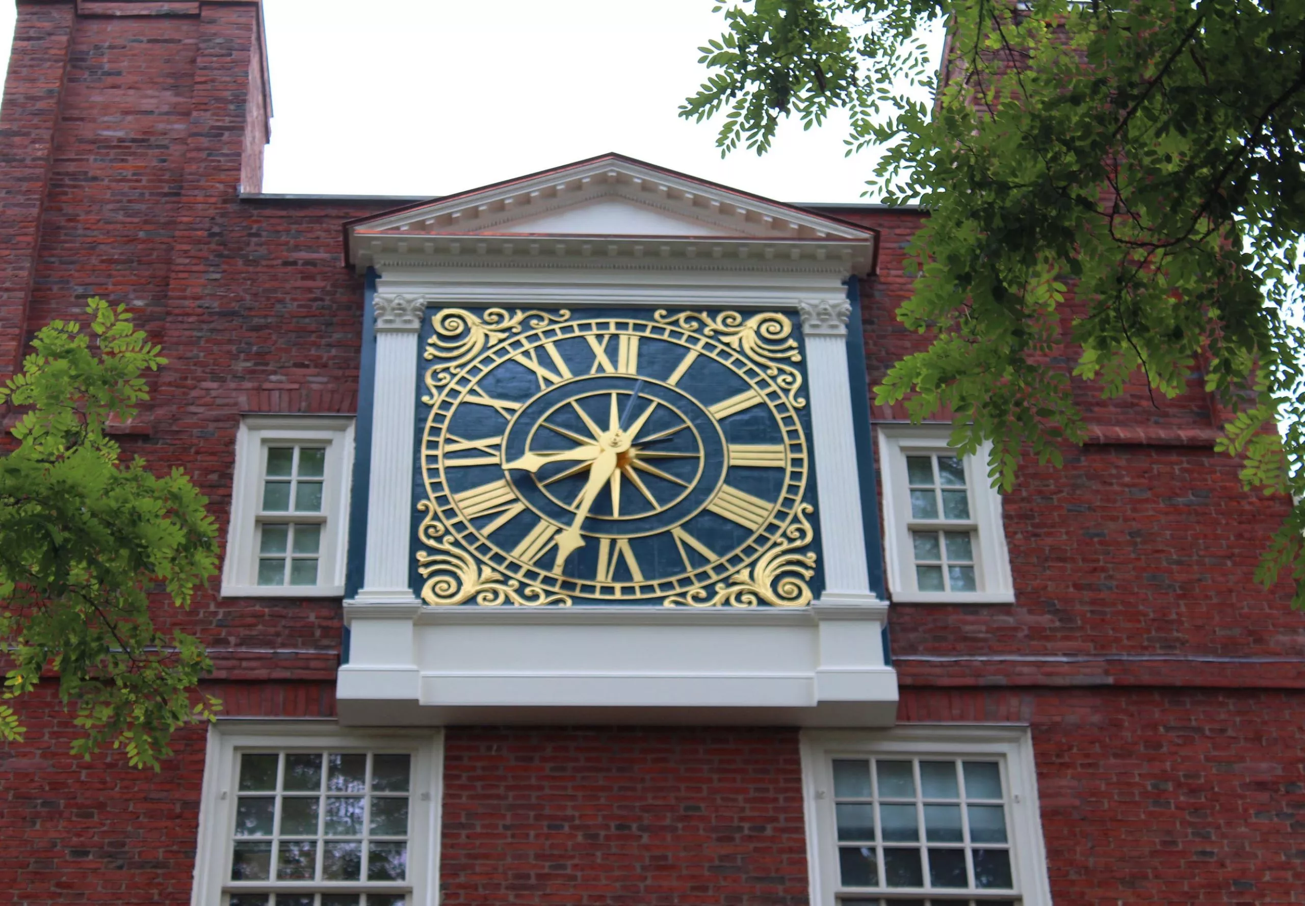 Large clock on the side of Massachusetts Hall