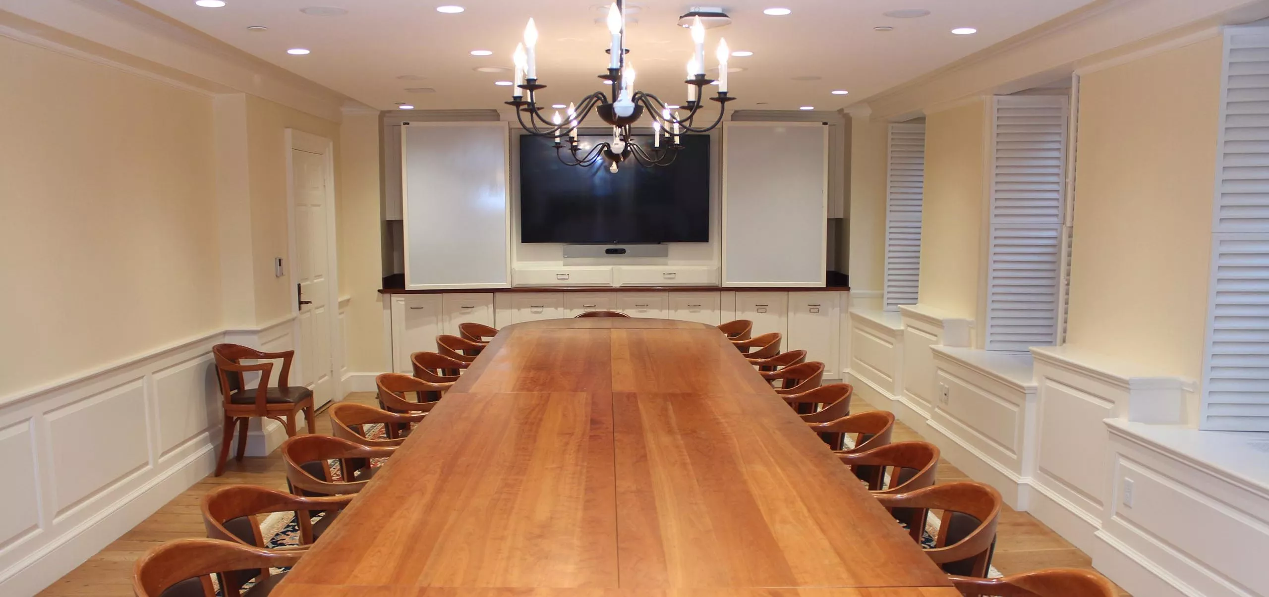 Large dining table and chairs inside Massachusetts Hall