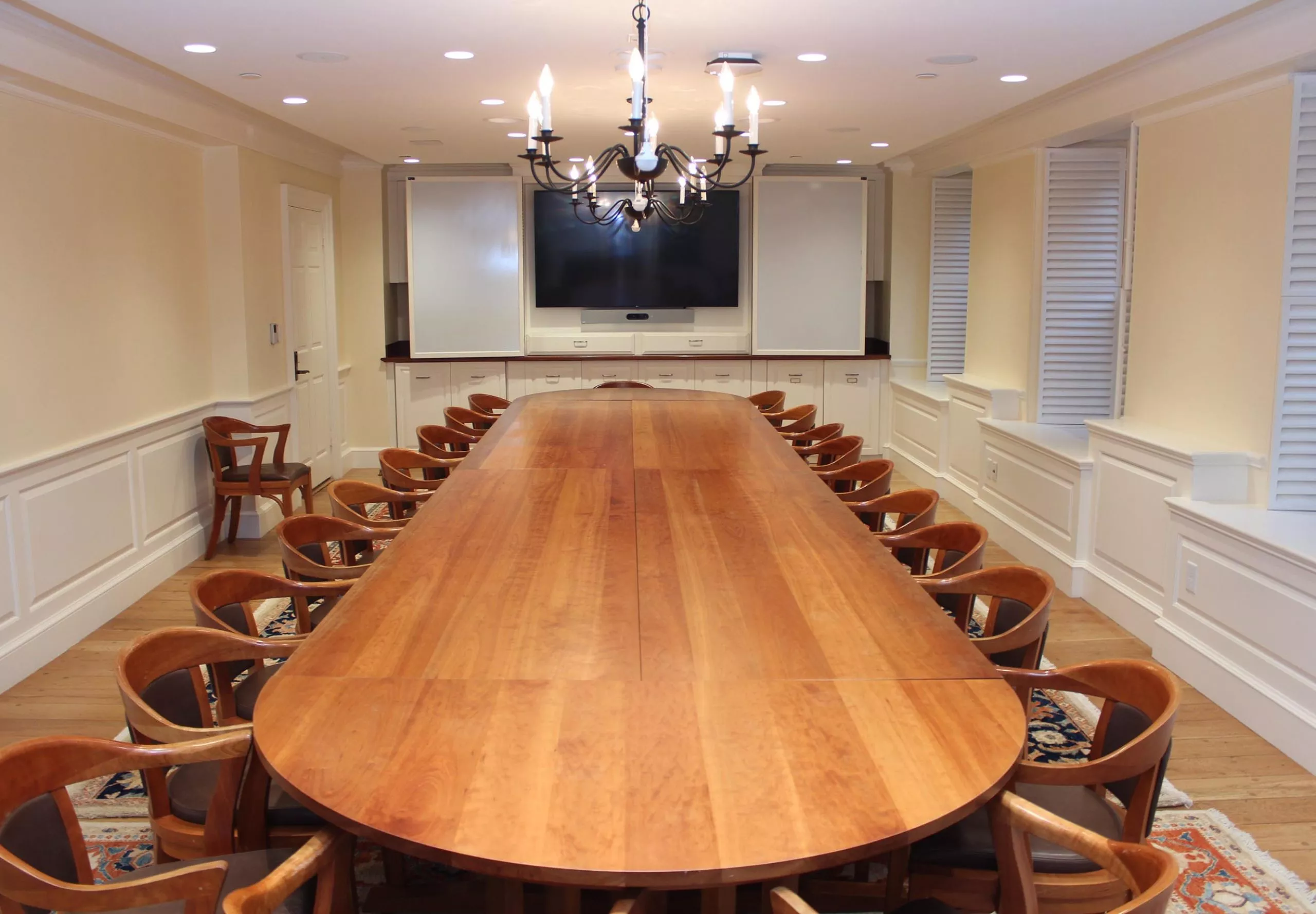 Large dining table and chairs inside Massachusetts Hall