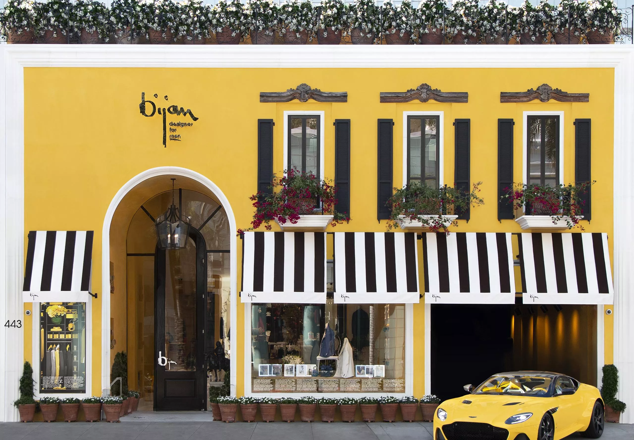 exterior view of house of bijan building with yellow sports car out front