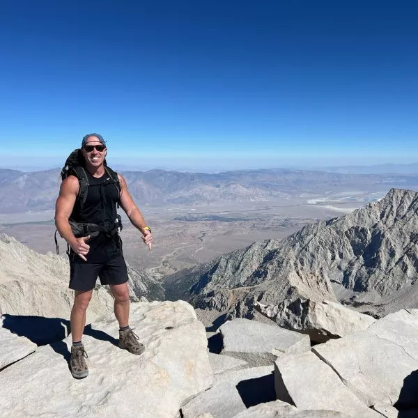 Chris Hennessy on top of a mountain