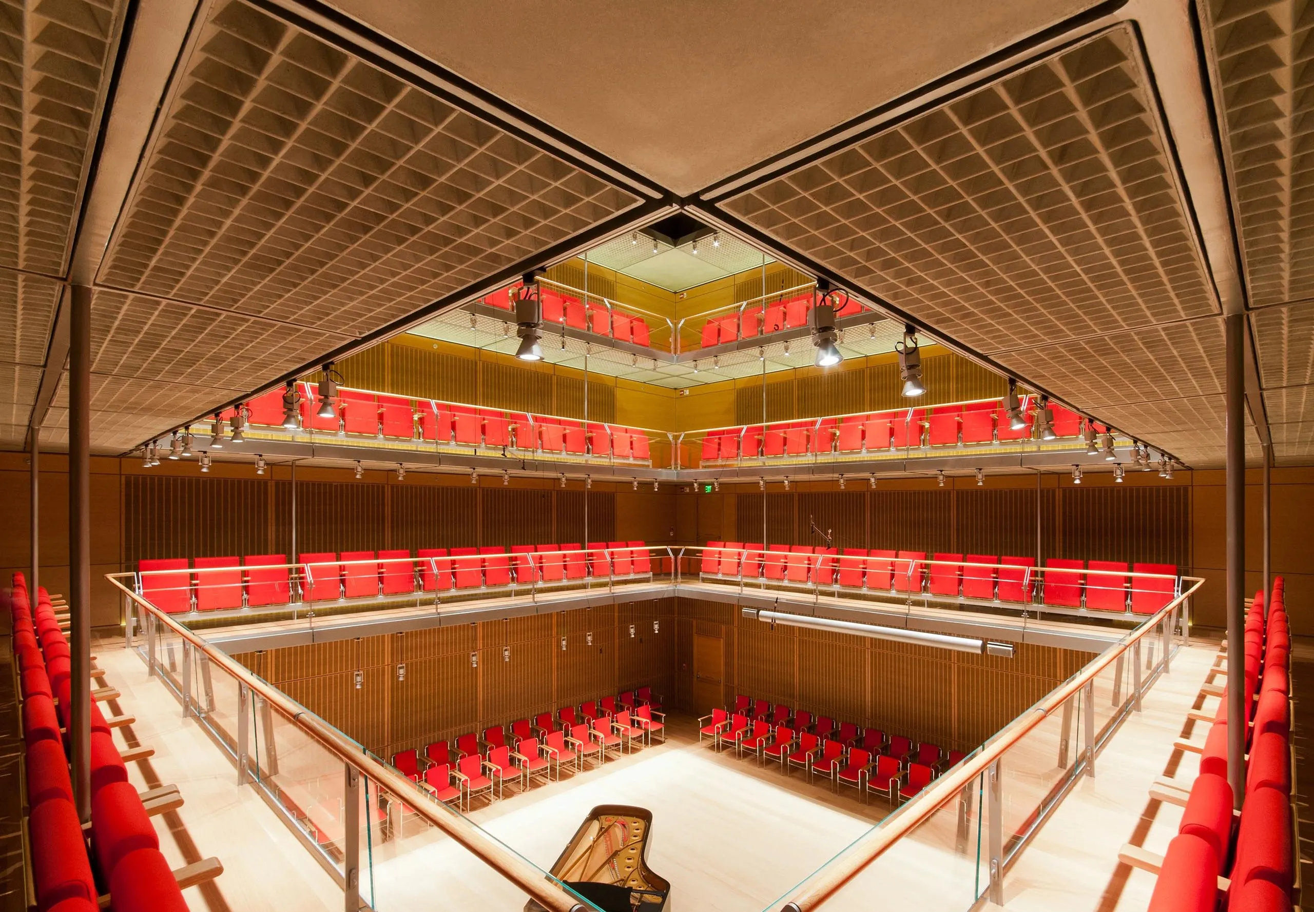 Vertical auditorium surrounding piano in center of room at Isabella Stewart Gardner Museum