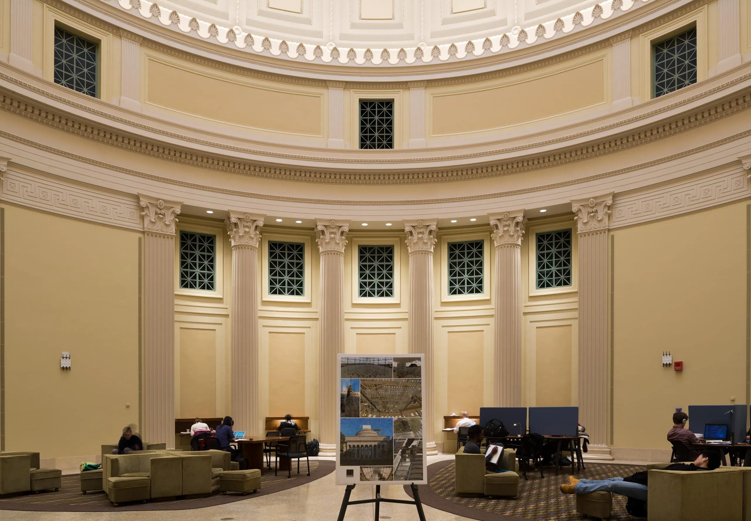 a large room with columns and a large picture frame