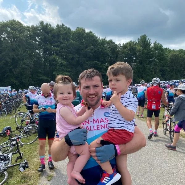 Mike Christopher with two children at a bike race