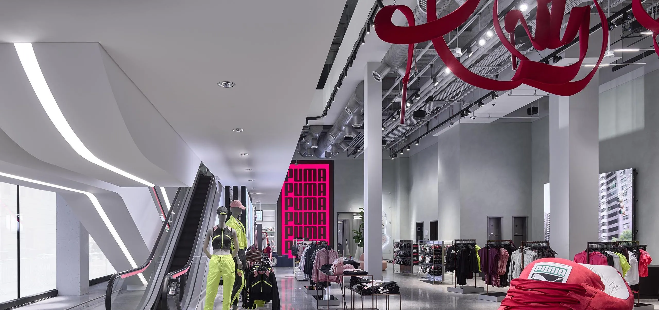 Interior of PUMA store with escalator and giant shoe