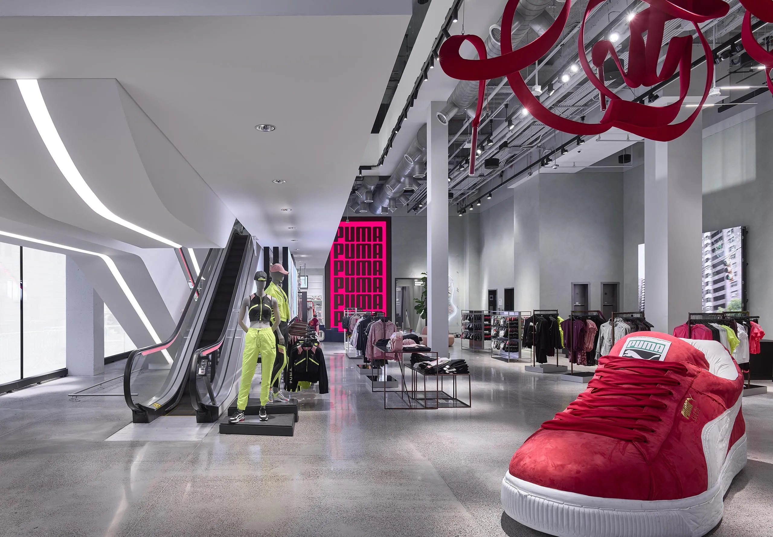 Interior of PUMA store with escalator and giant shoe