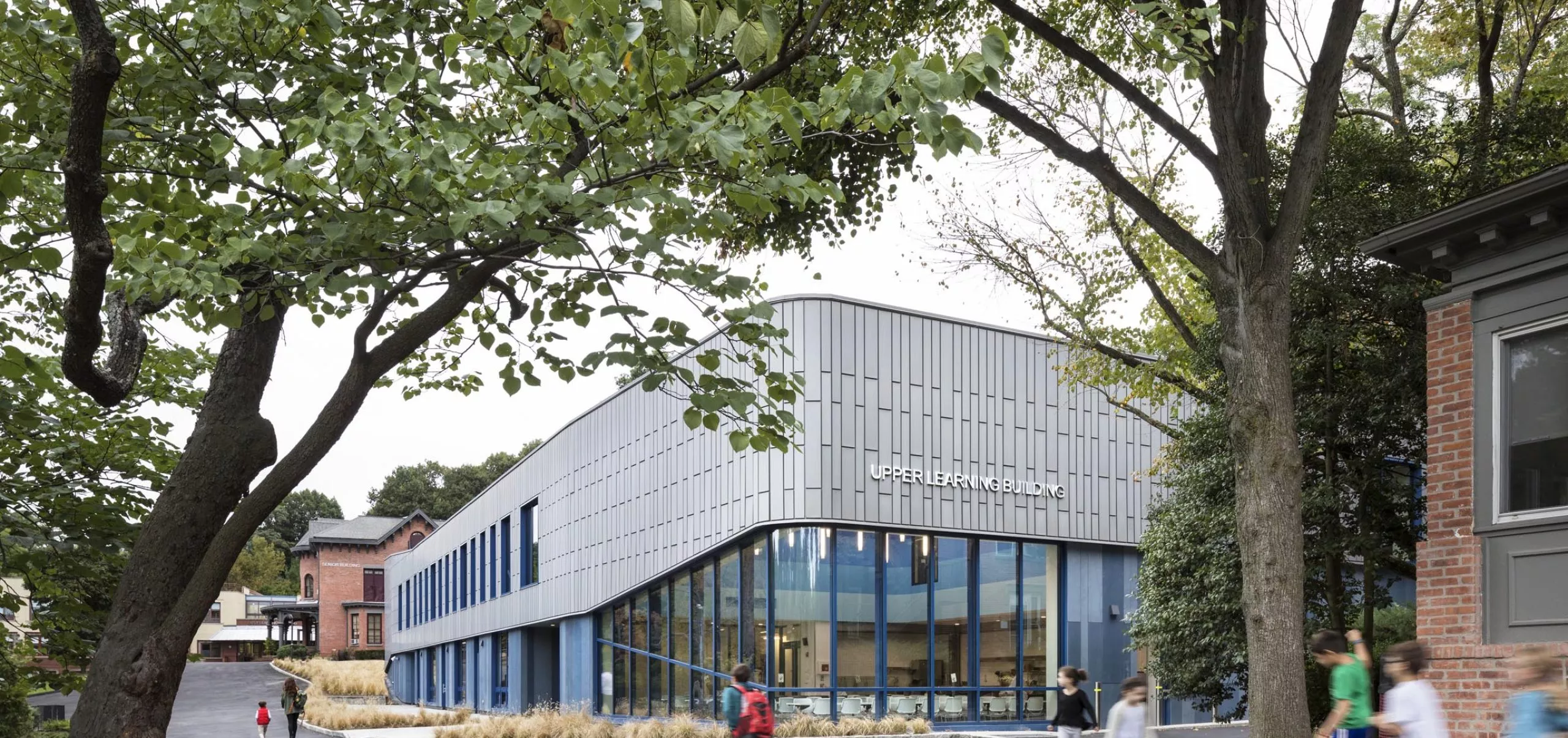 Students walking on pathway outside Riverdale Country School Upper Learning Building