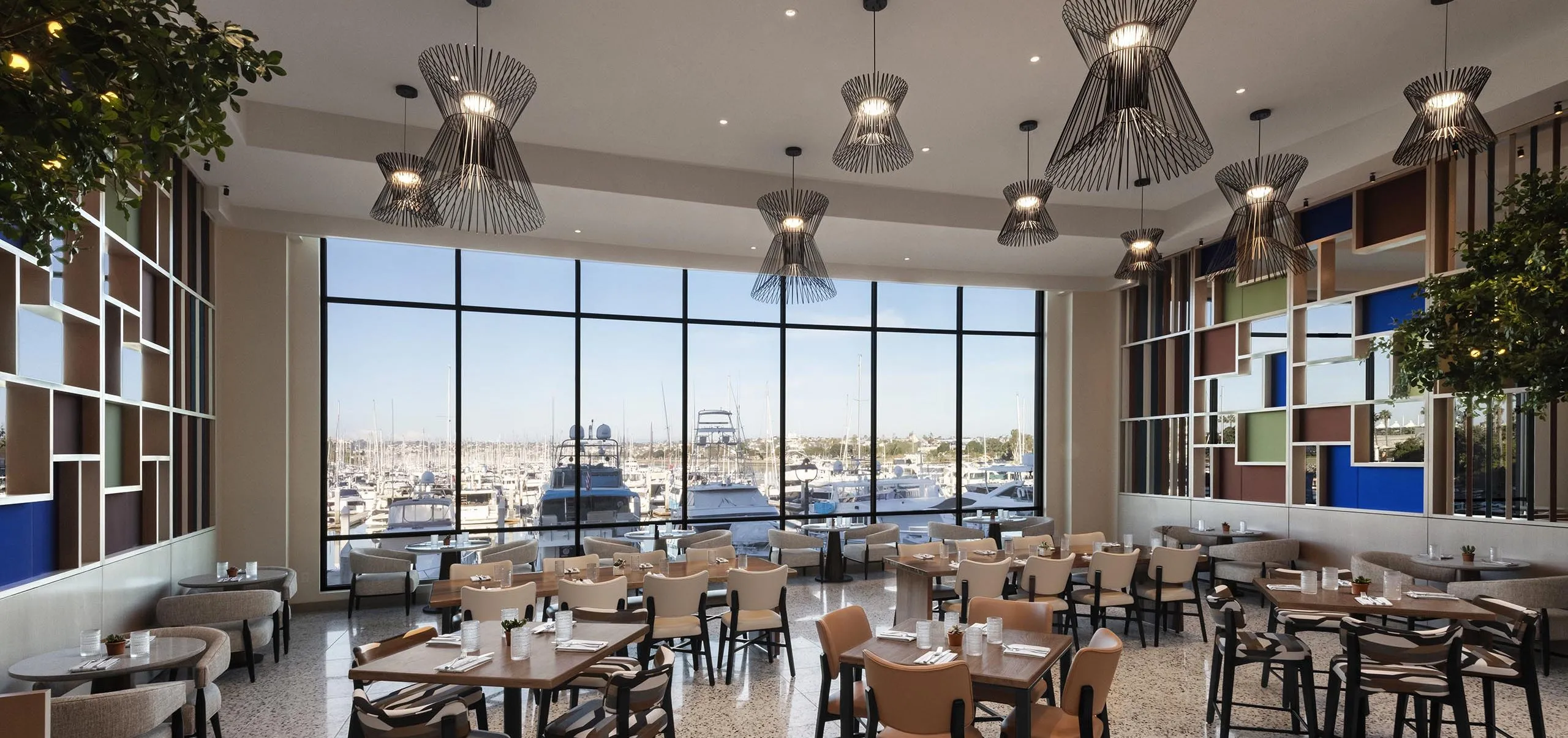 Interior view of the dining room and large window at the Sheraton San Diego Hotel