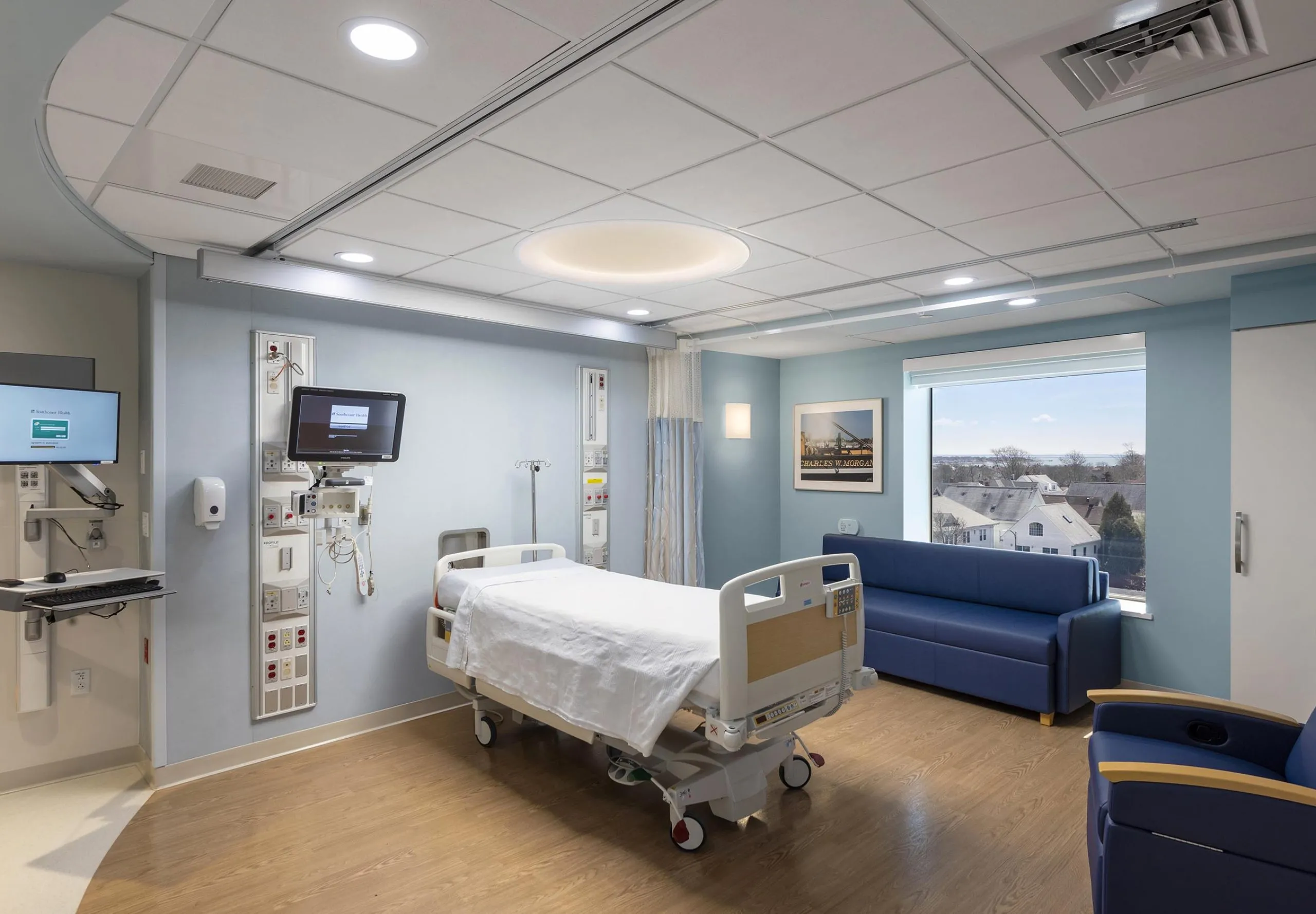 Interior view of a hospital room with a blue couch and chair at St. Luke's Hospital