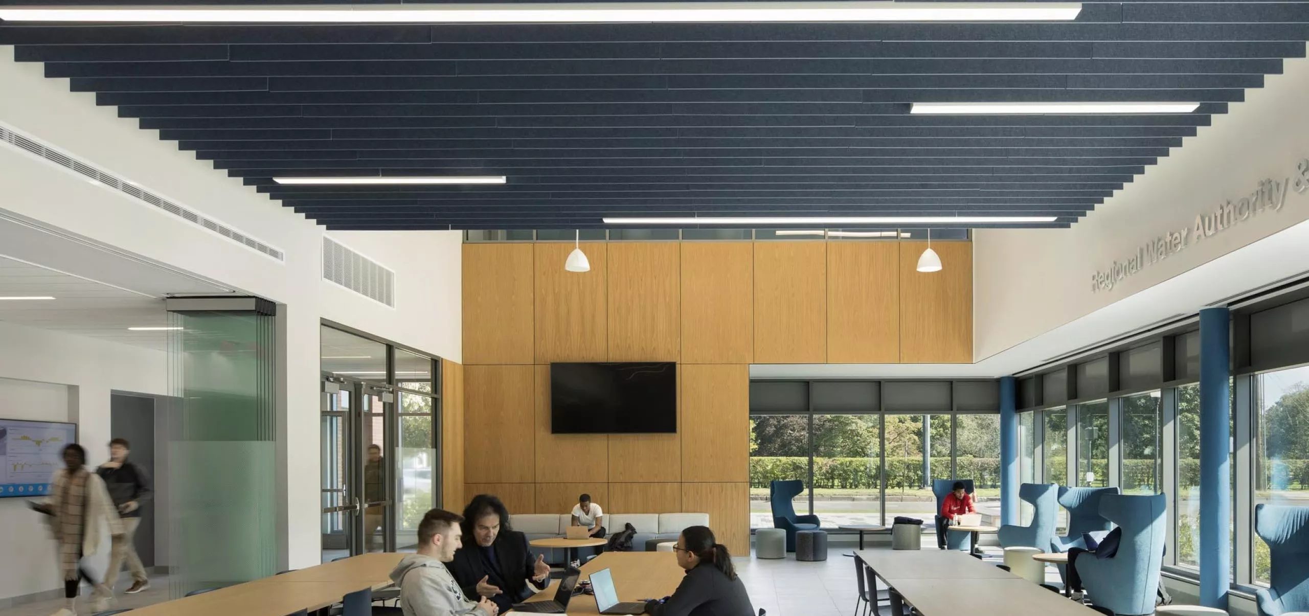 People sitting at communal tables in Southern Connecticut State University School of Business