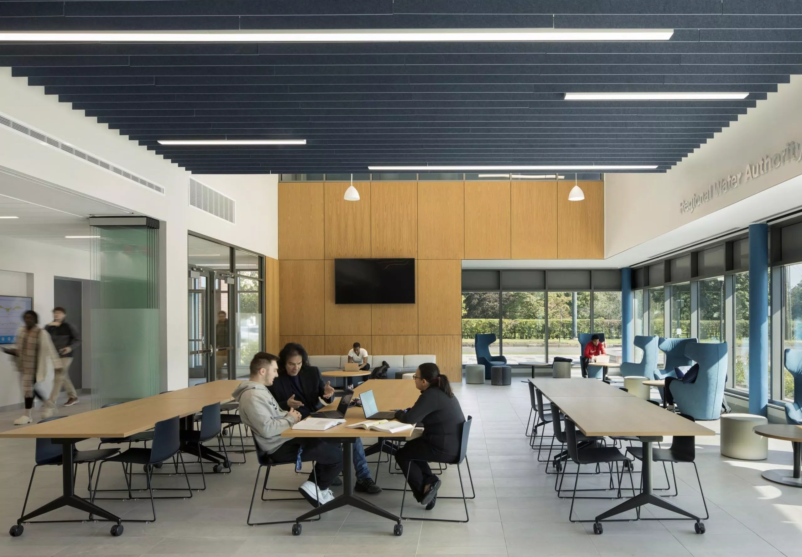 People sitting at communal tables in Southern Connecticut State University School of Business