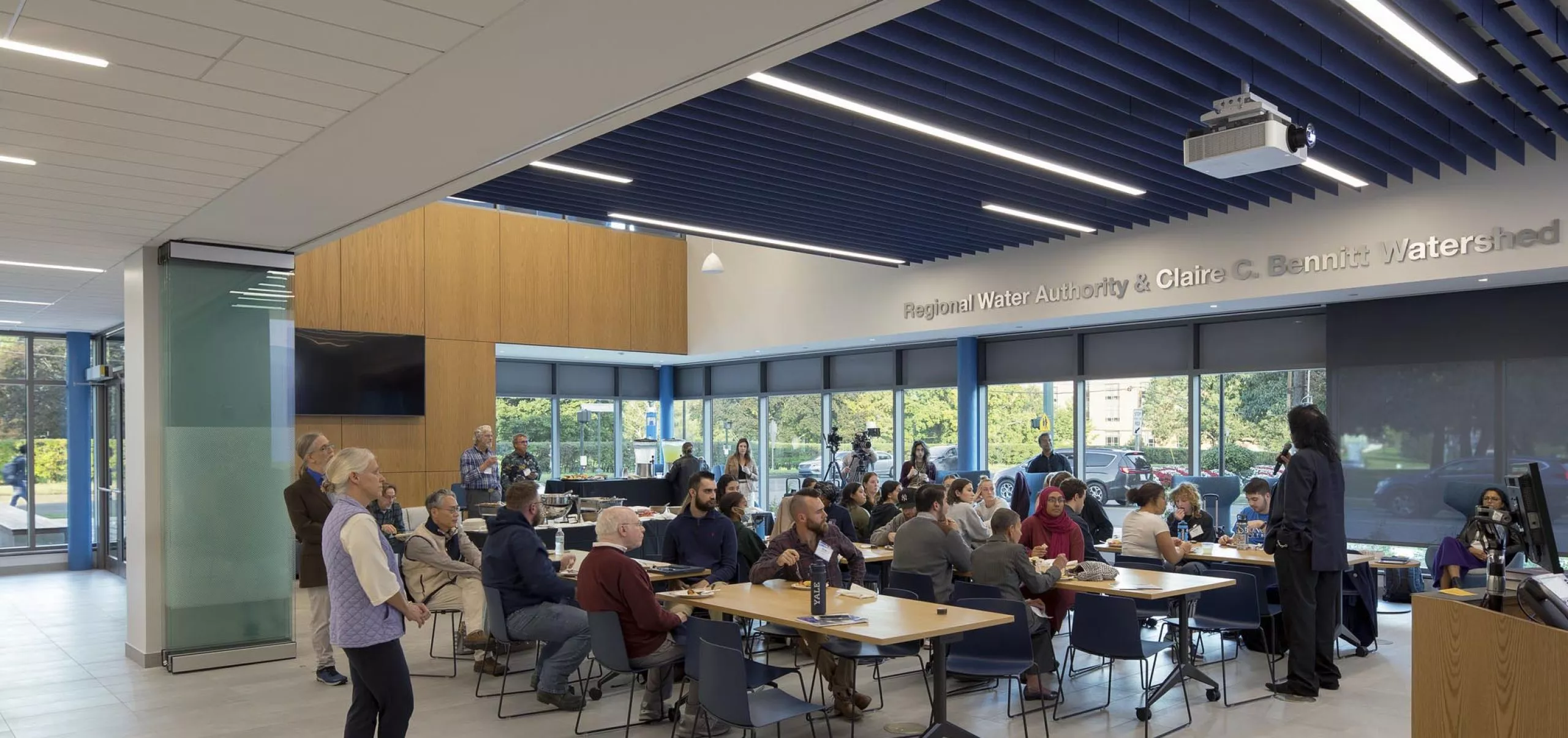 People sitting at communal tables in Southern Connecticut State University School of Business