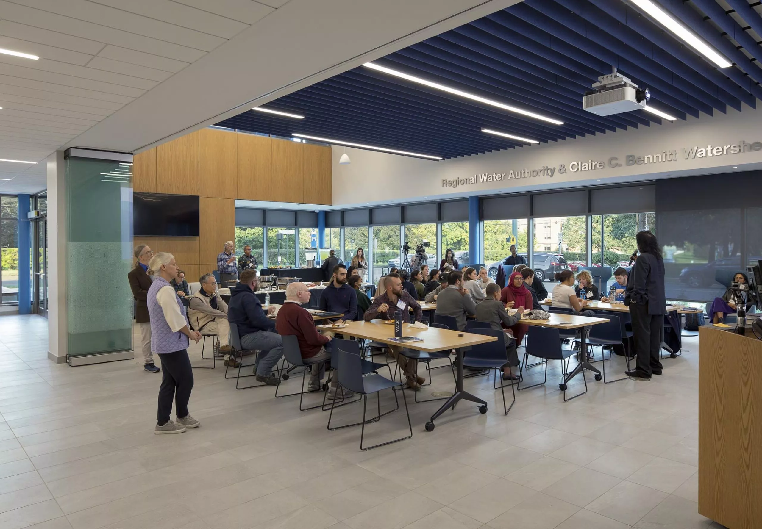 People sitting at communal tables in Southern Connecticut State University School of Business