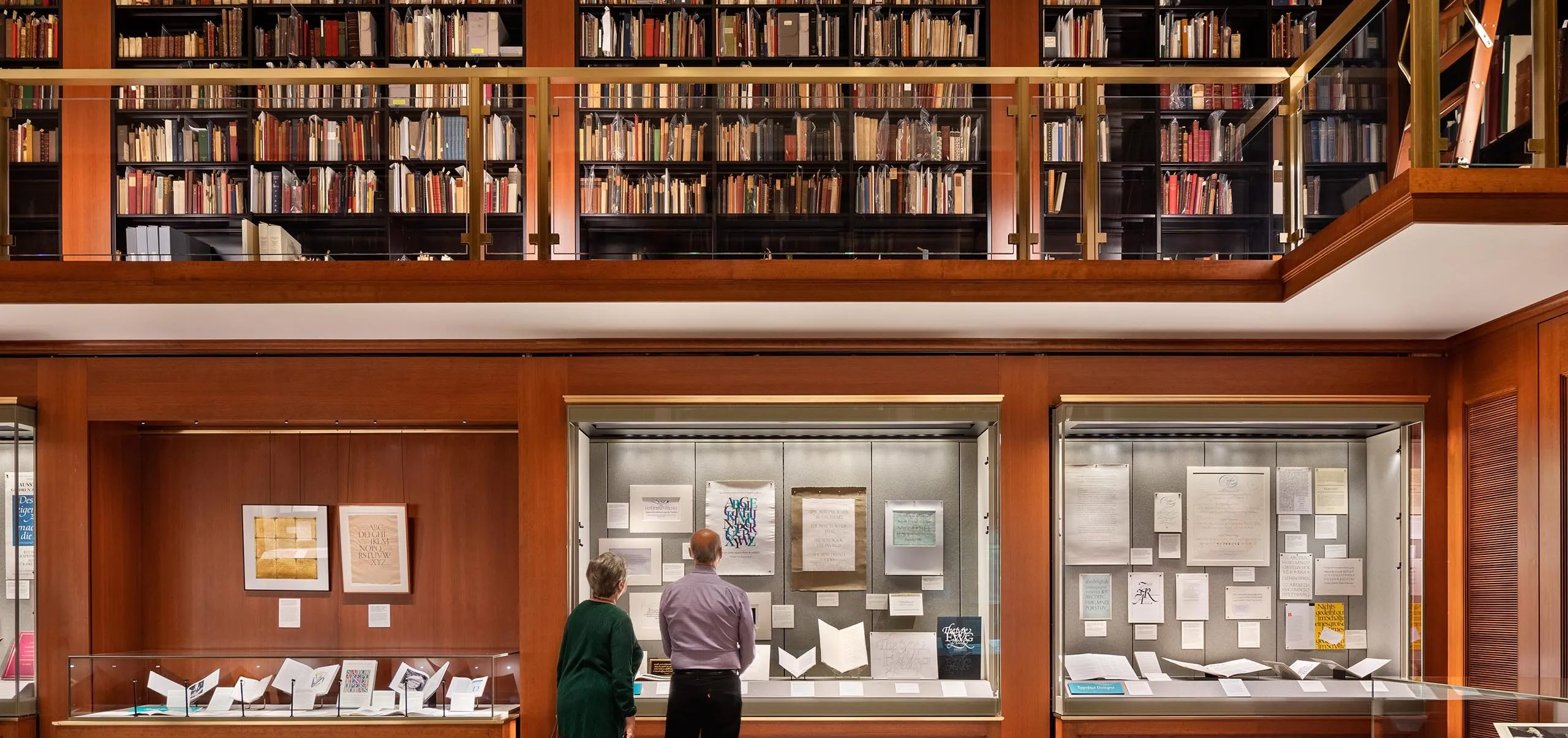 People looking in display cases at the Grolier Club