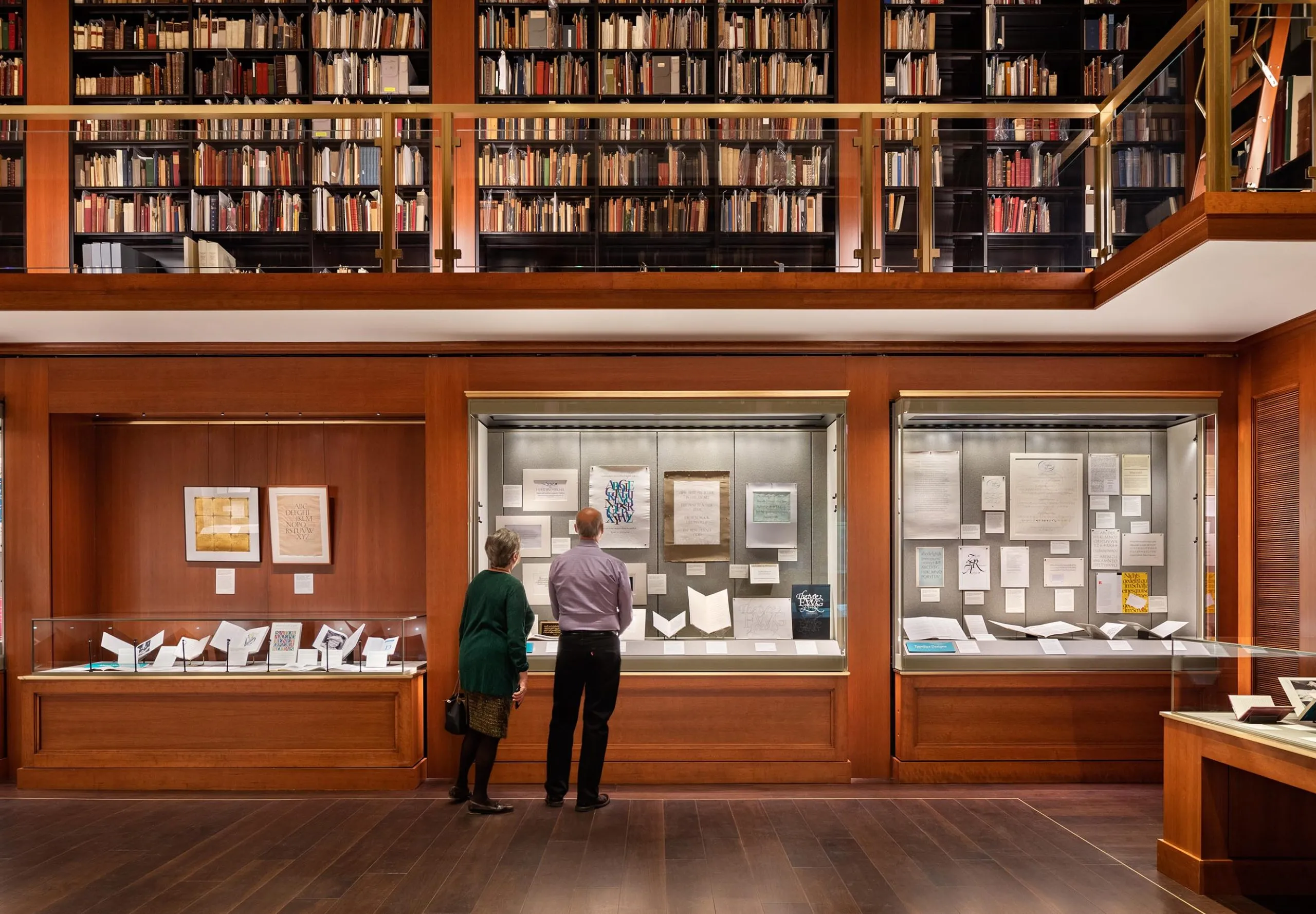 People looking in display cases at the Grolier Club