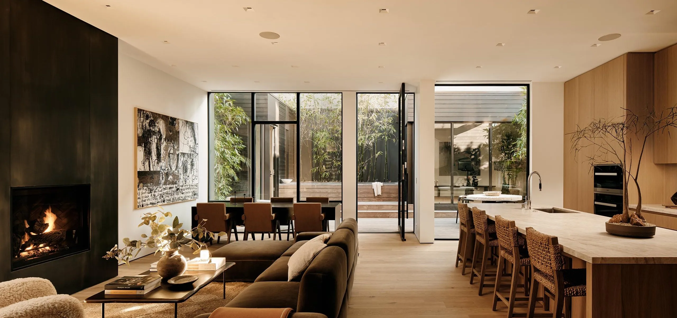 interior view of the kitchen and living room with fireplace and dining table