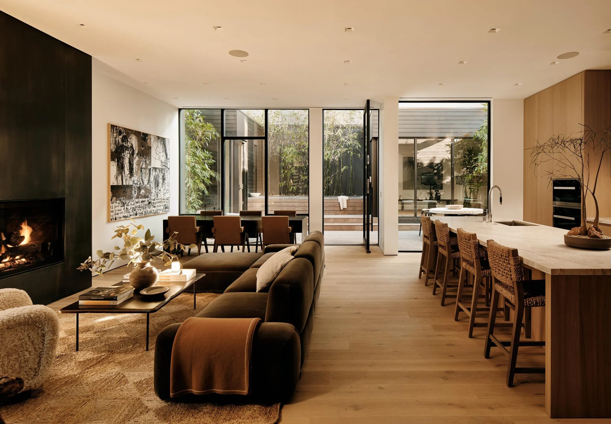 interior view of the kitchen and living room with fireplace and dining table