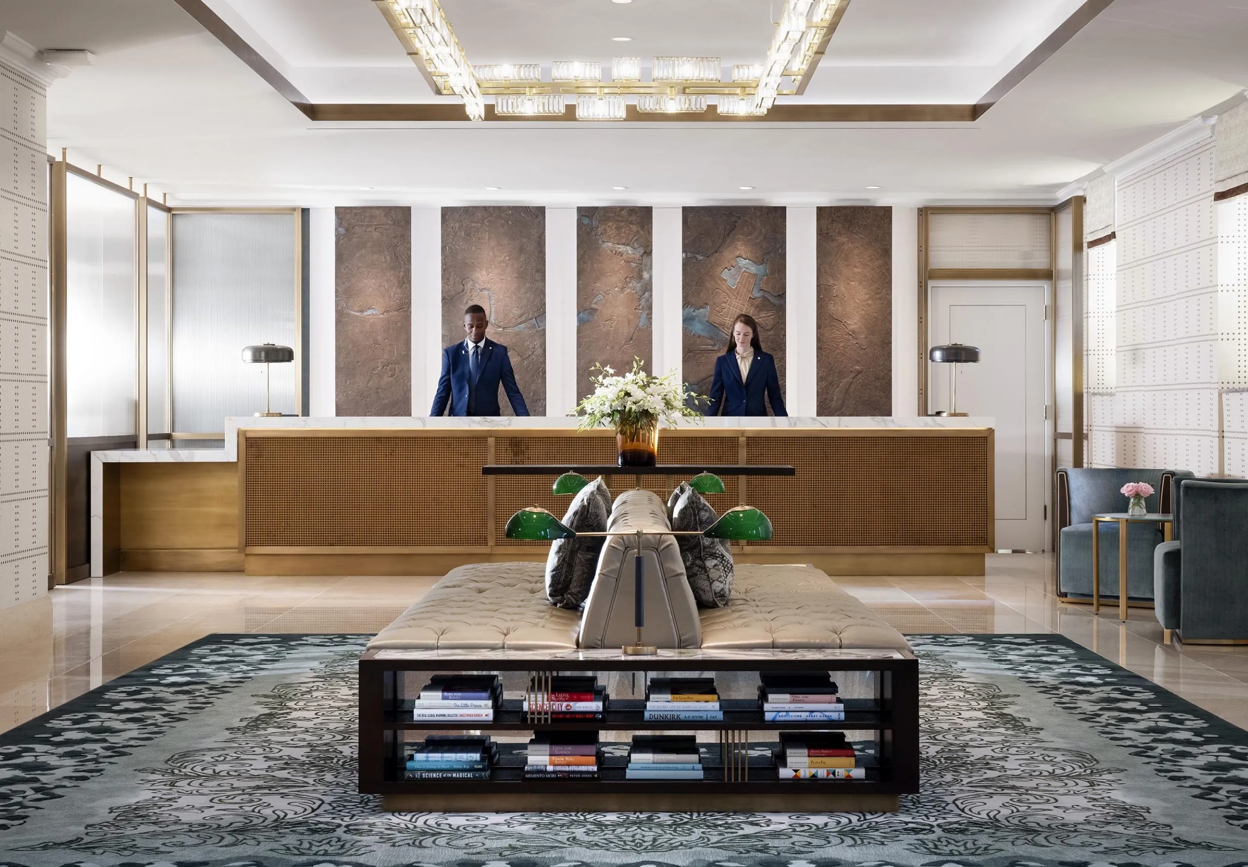 Interior view of the lobby with two employees at The Langham Boston