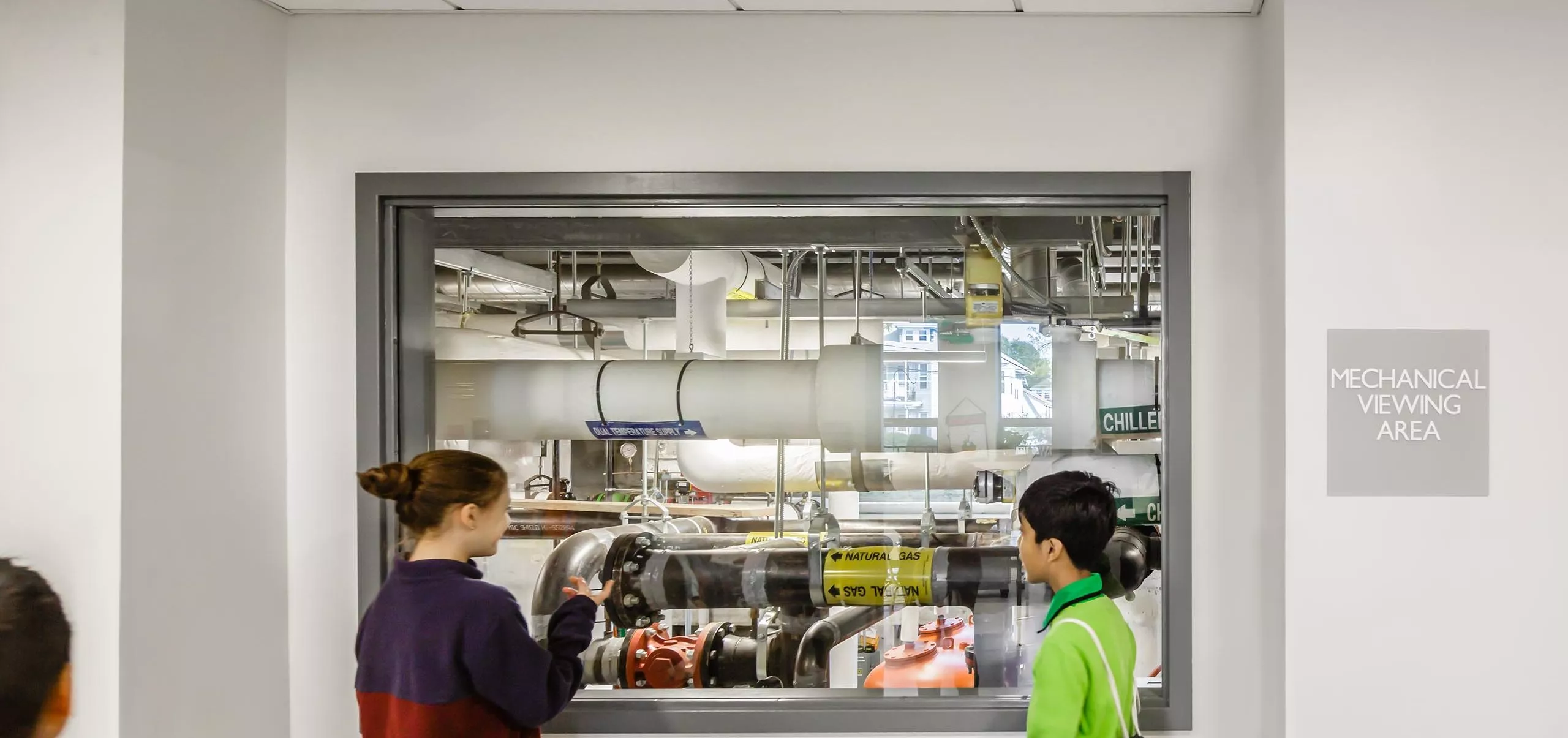 Students looking at mechanical viewing area at Gibbs School