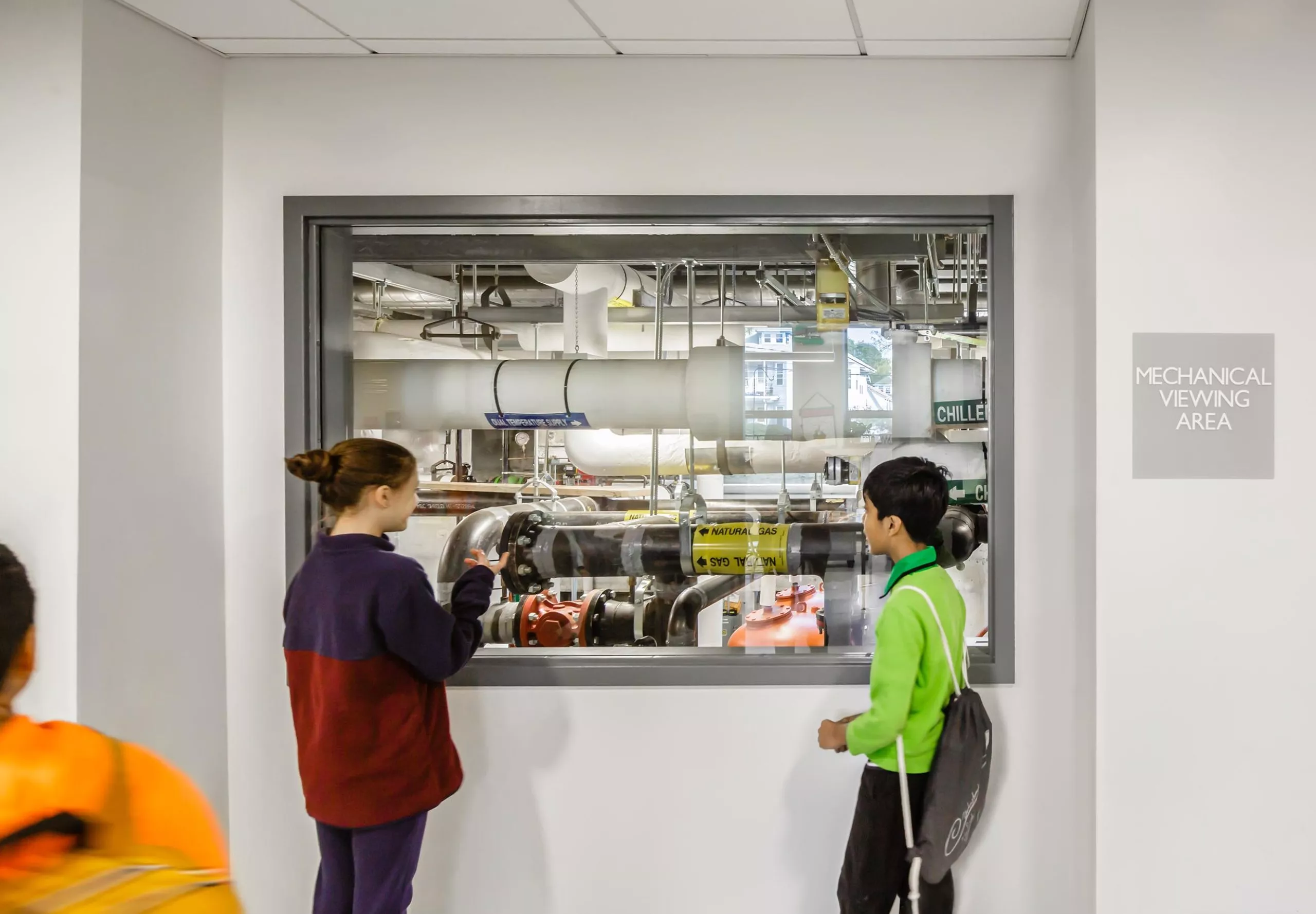 Students looking at mechanical viewing area at Gibbs School