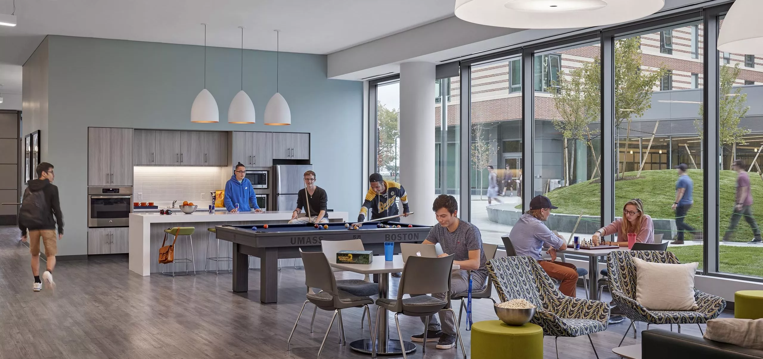 Kitchen, pool table and communal dining space inside UMass Residence Hall