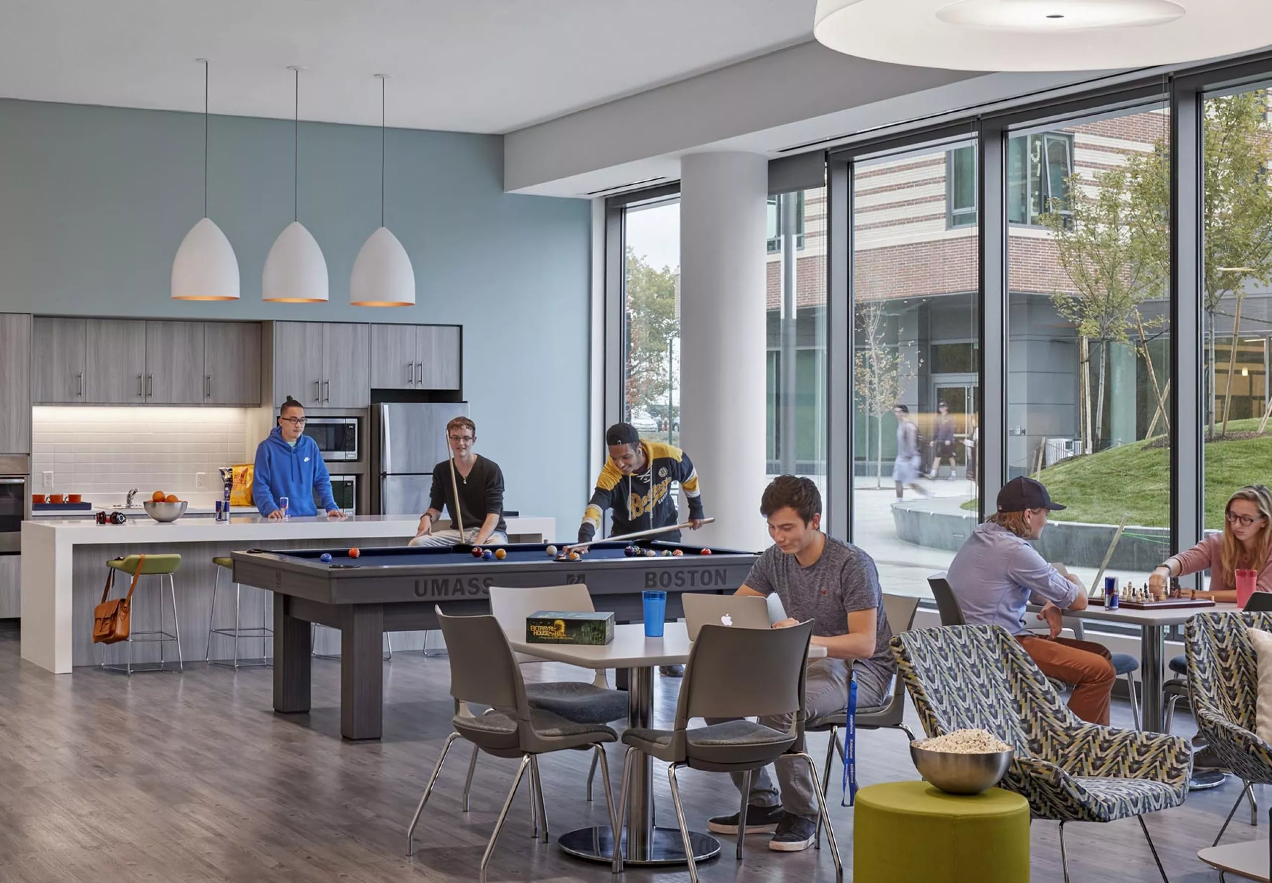 Kitchen, pool table and communal dining space inside UMass Residence Hall