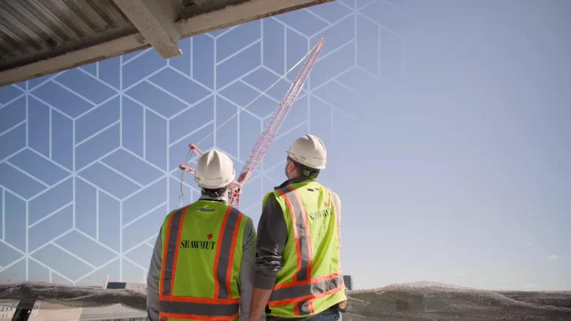 Two men in safety gear on a construction site